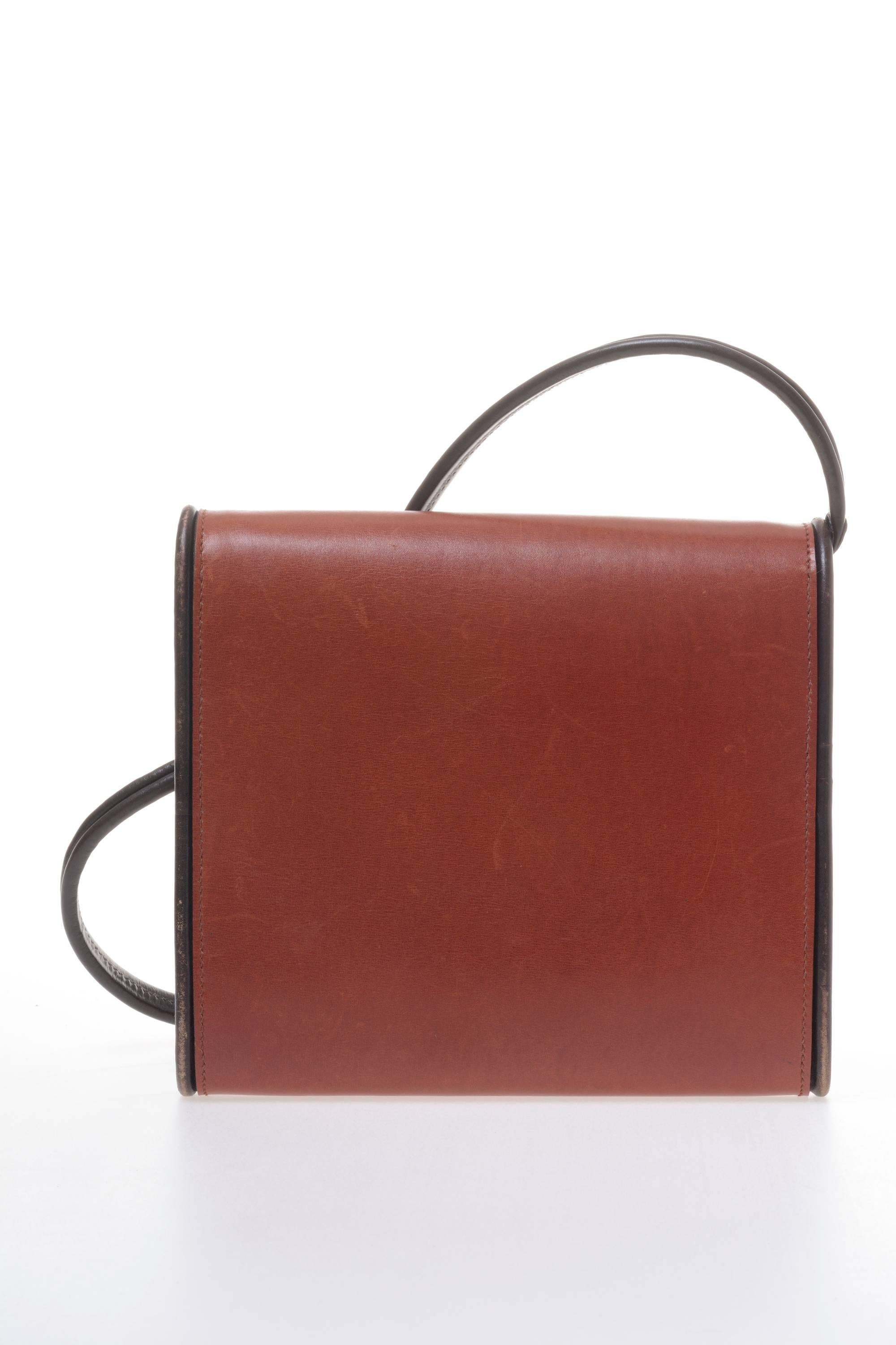 This lovely 1970s envelope clutch bag by HERMES has been made by hand in Italy, made of brown leather and fully lined with nude leather, the hems have a dark brown colour with decorative sewing, a shoulder strap that could be removed and a Button