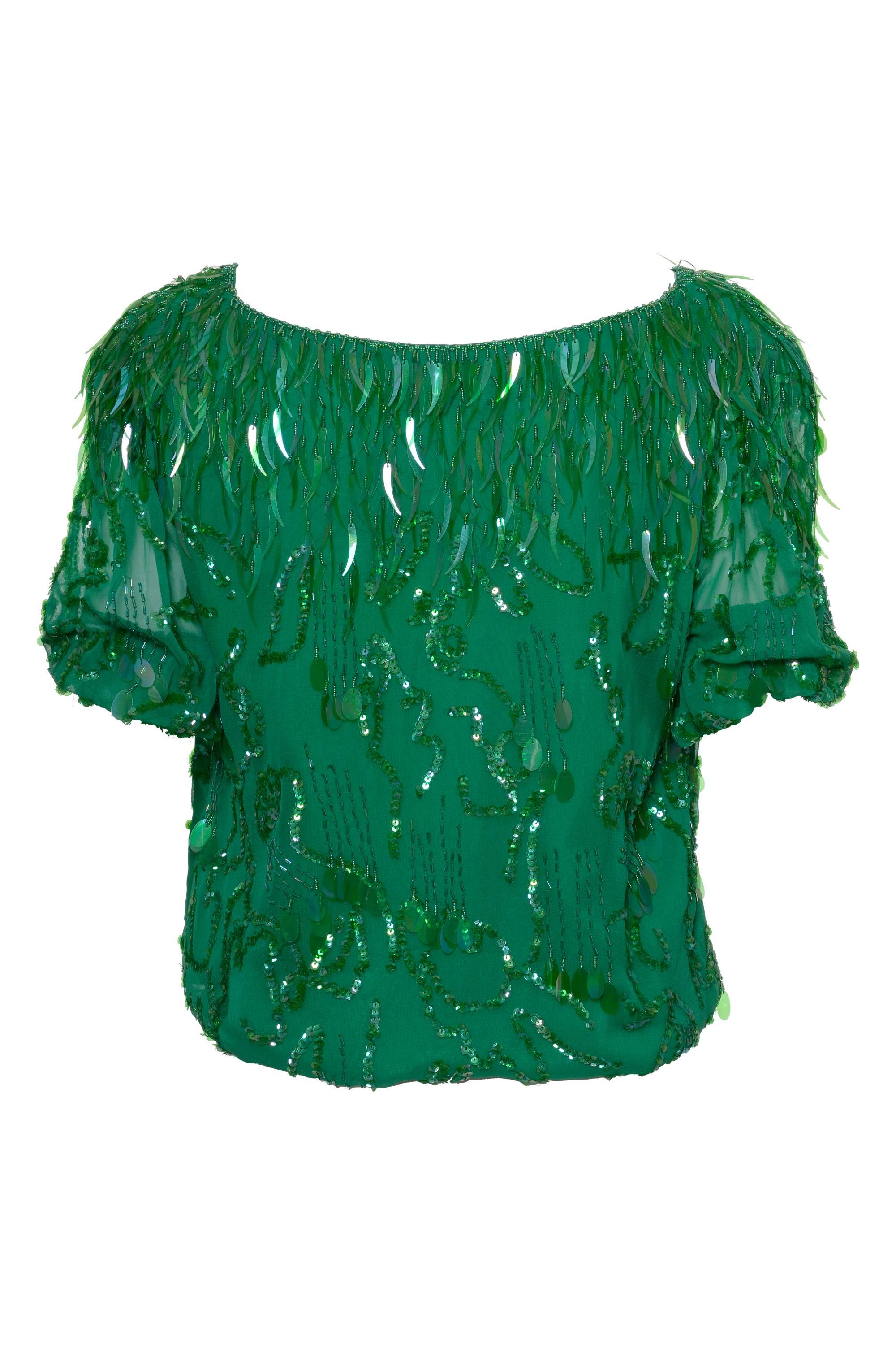 This 1980s amazing green balloon blouse by OLEG CASSINI has been fully embroidered by hand using fantasy seed and bugle beads, cup and flat sequins, V-neckline,  short balloon sleeves, pad shoulders, and gathered hems. It is made of green sheer