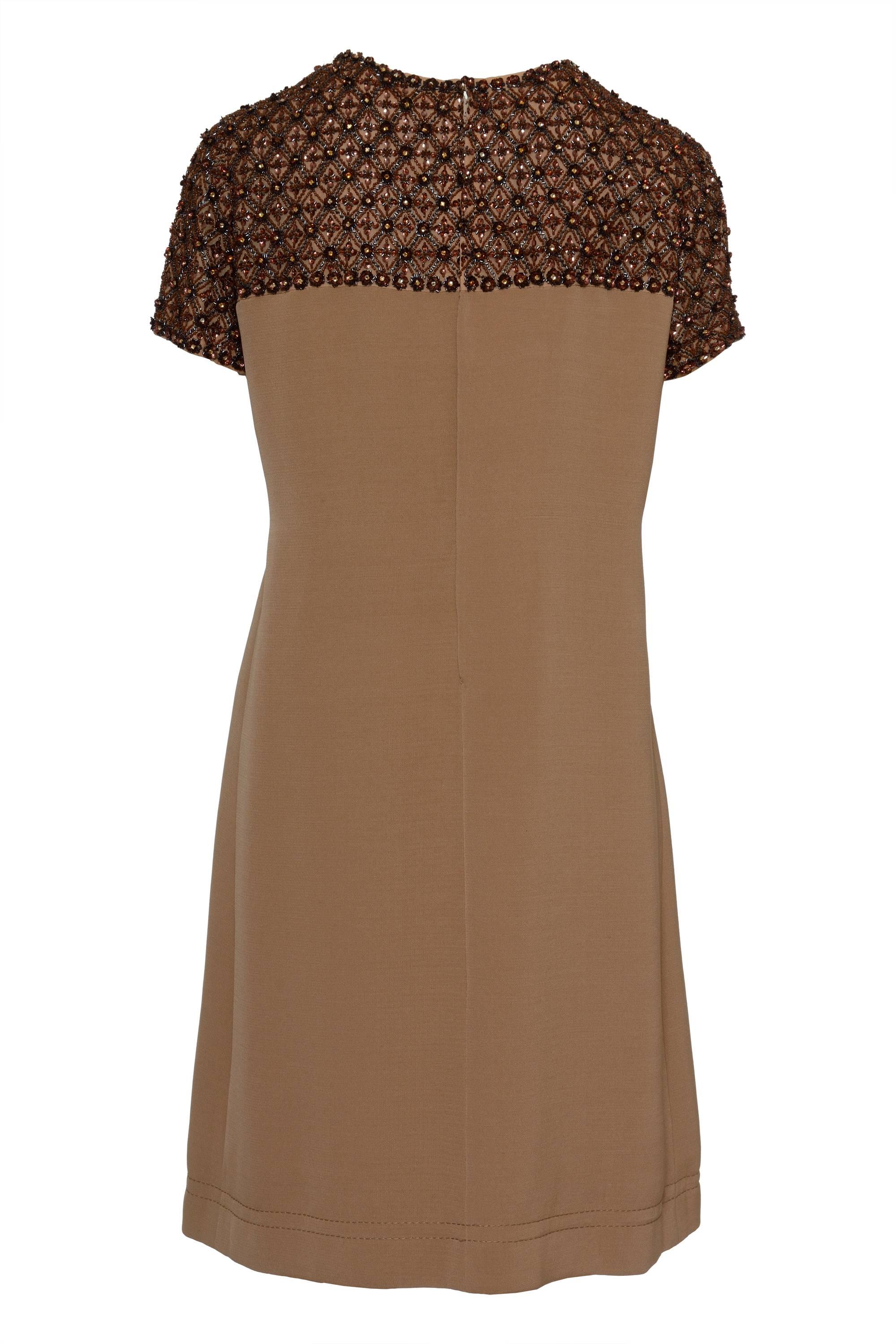 This 1960's lovely brown cocktail mod dress by T. PRATA (an Italian Tailor) has an embroidered yoke and sleeves, made by hand with seed, bugle beads and cup sequins doing rhombus and flower shapes. It is fully lined with silk and has back zip, hook,