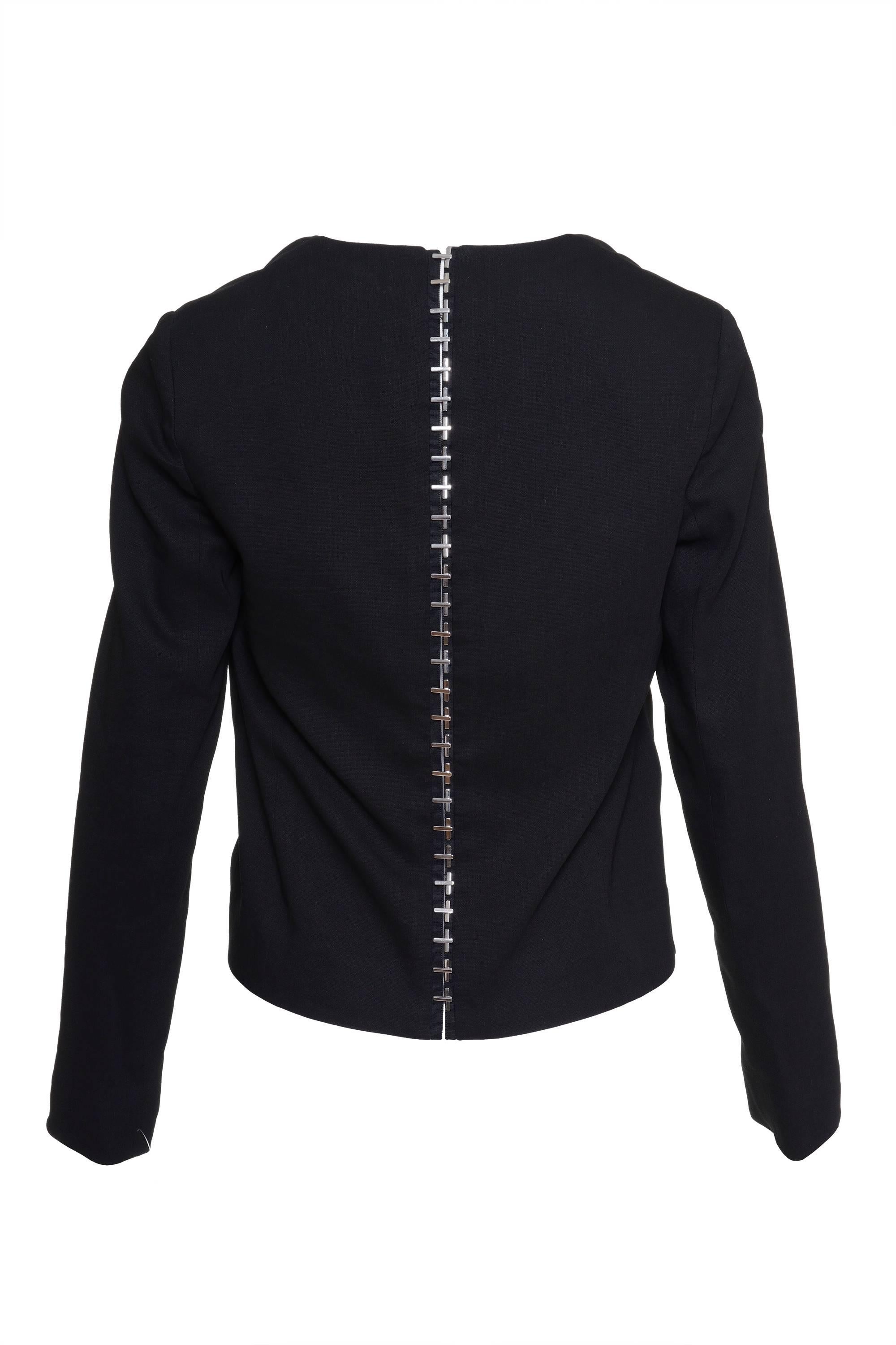 This amazing black tie waist jacket by VERSACE has two front jetted pockets, shoulder pads, tailor seam, two-piece sleeves, and a line of special metal details hook and bars from the neck to the hem. It has a chain label and is made in