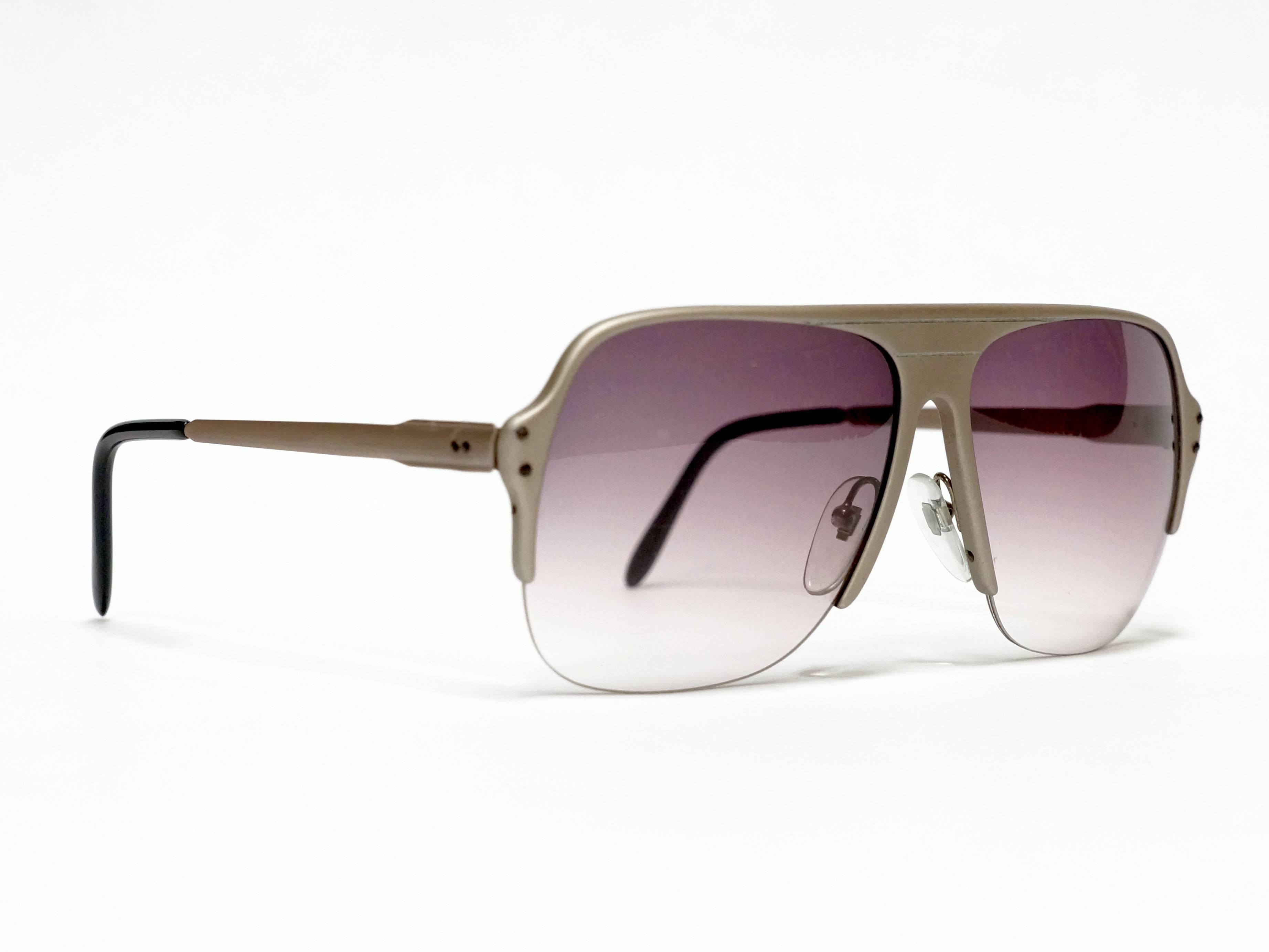 1980's oversized half rimmed metal vintage sunglasses by Lamborghini, made in Italy in new old stock condition. 

Model: 4021

approximate dimensions:
temple length: 140mm - 5 1/2