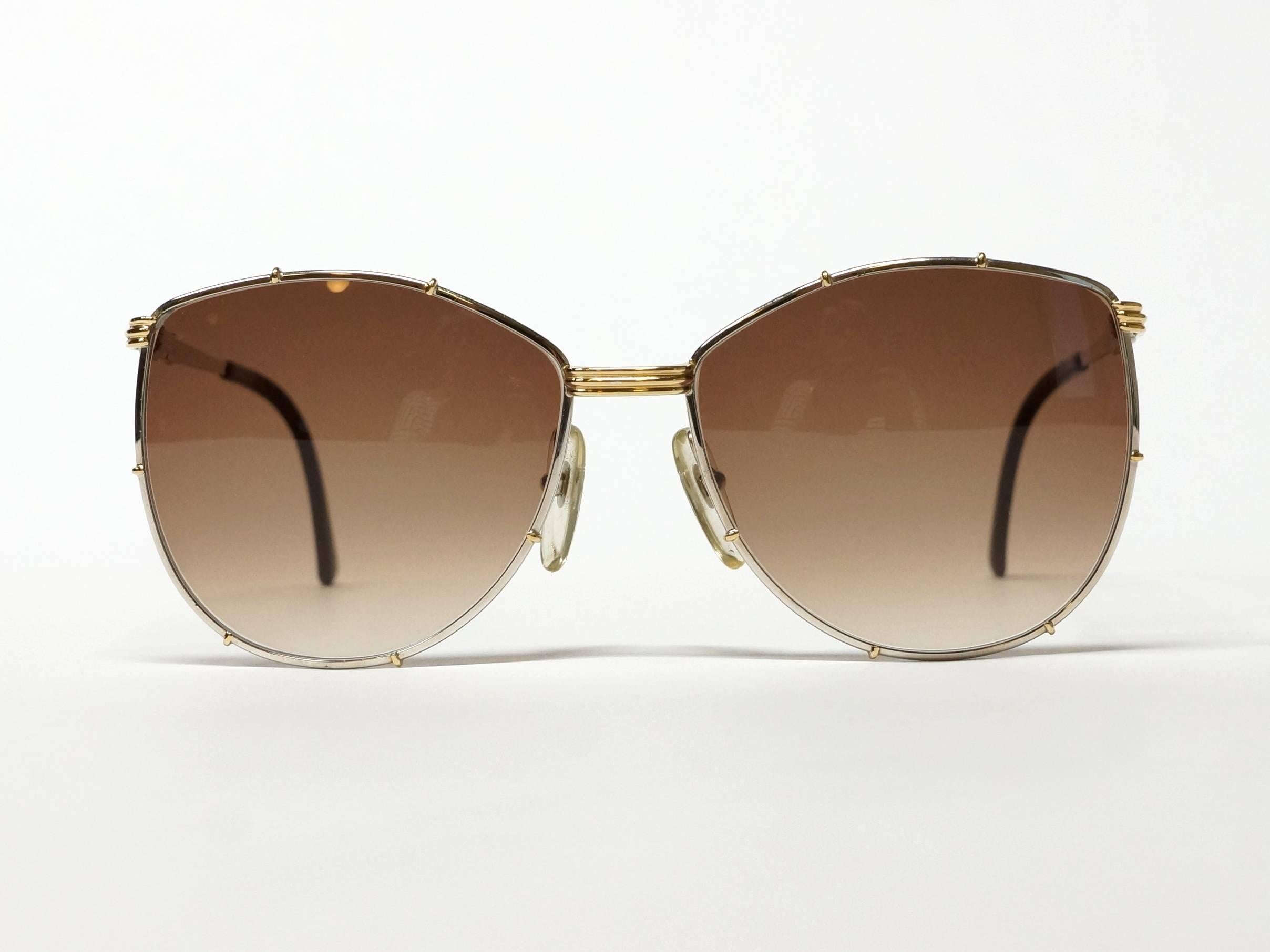 Classic 80s vintage bicolor - gold/silver - sunglasses by Christian Dior made in Austria. High quality metal frame in new old stock condition. 

Model: 2249
color: 47
size: 59◻16 - 135

approximate dimensions:
temple length: 130mm - 5