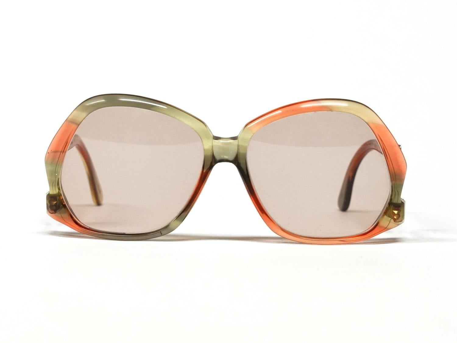 Flashy vintage sunglasses made in the 1970s by the German company Hampel. Green red translucent acetate frame with drop temples which swinging go up.

approximate dimensions: 
temple length: 135mm - 5 15/16