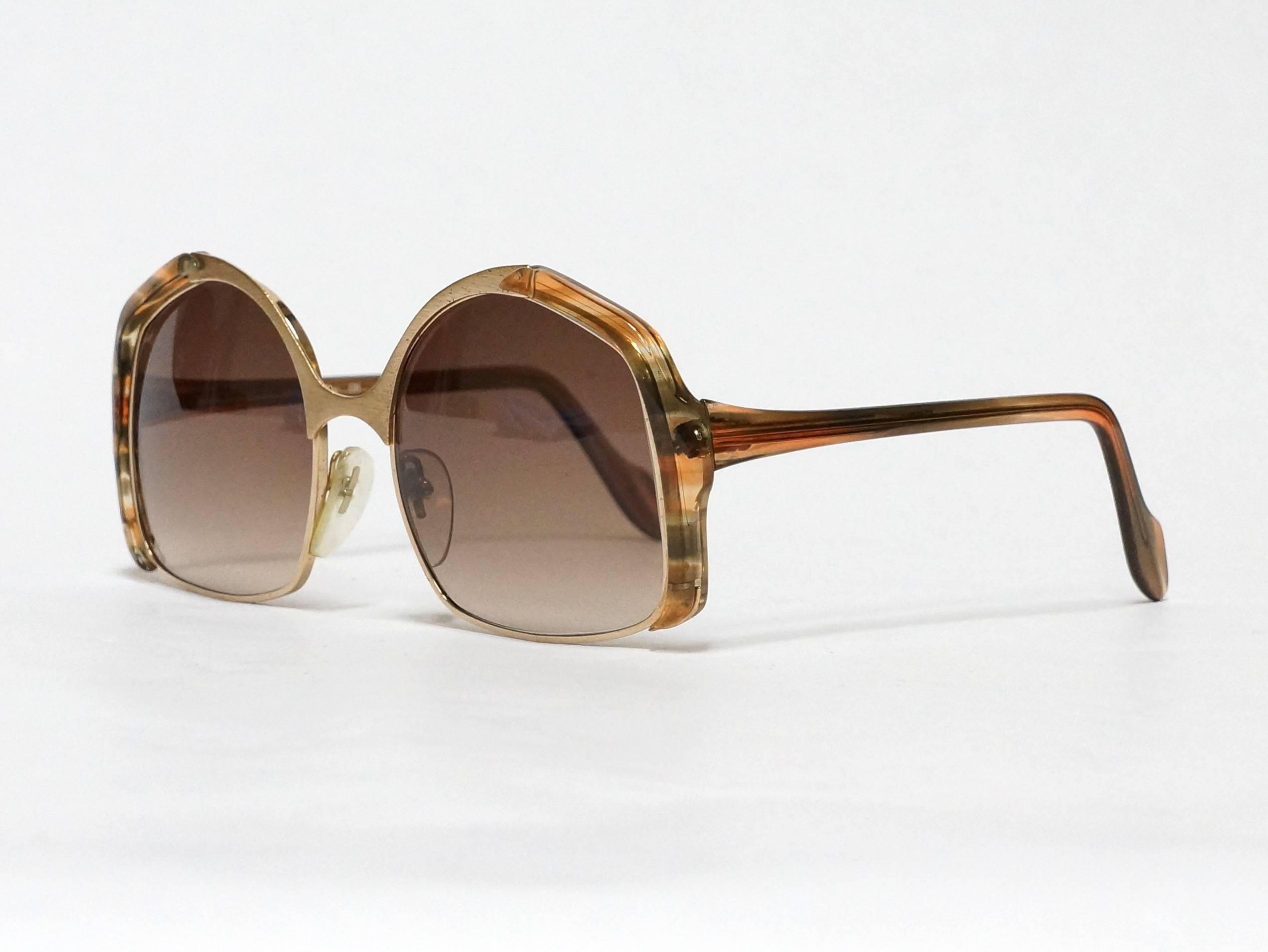 1970's vintage sunglasses by Neostyle, made in Germany. Gold metal optical frame with brushed metal highlights, acetate temples and side accents in new old stock condition. 

Model: Office 5
size: 54▢18 -135

approximate dimensions:
temple