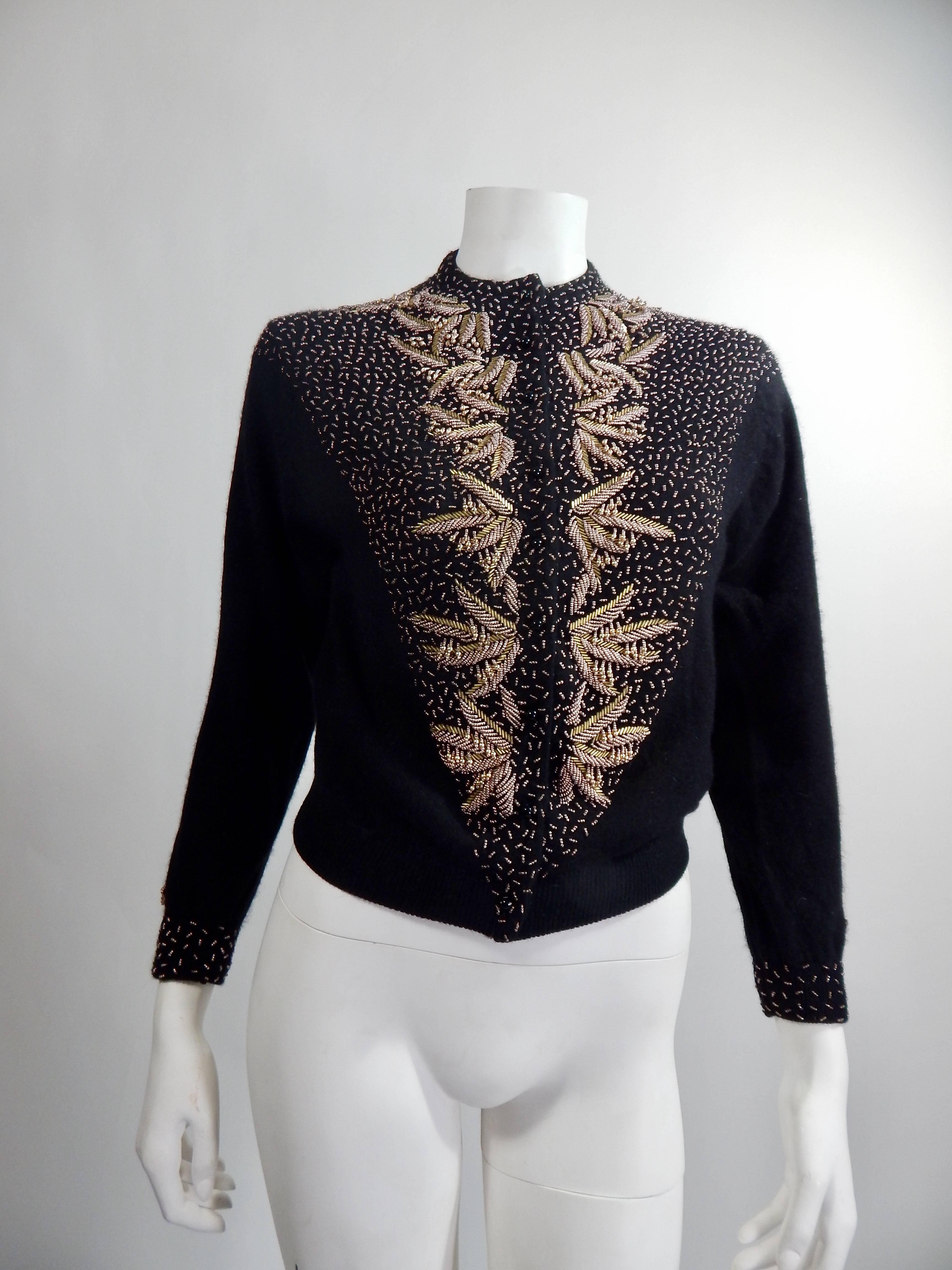 1950s Black Beaded Cardigan Sweater. Gold and Copper Beadwork. Black Silk. Lining. 70% Lambswool, 20% Angora, 10% Nylon. Size Small / Med. 
Measurements: Bust 35 , Length 22
