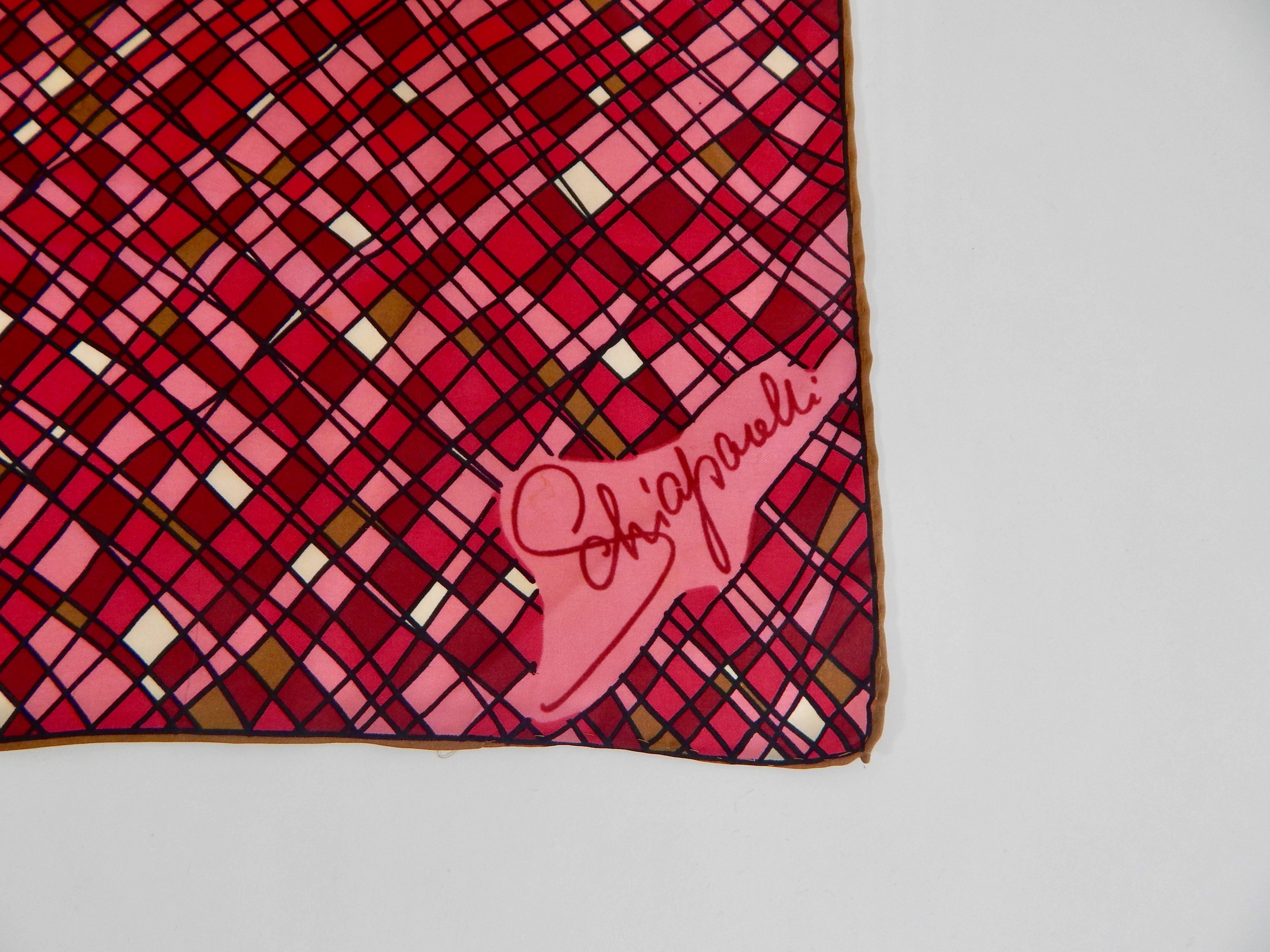 100% Silk. Signed Schiaparelli.  Multicolored includes pink, dark pink, raspberry, tan, brown and white.