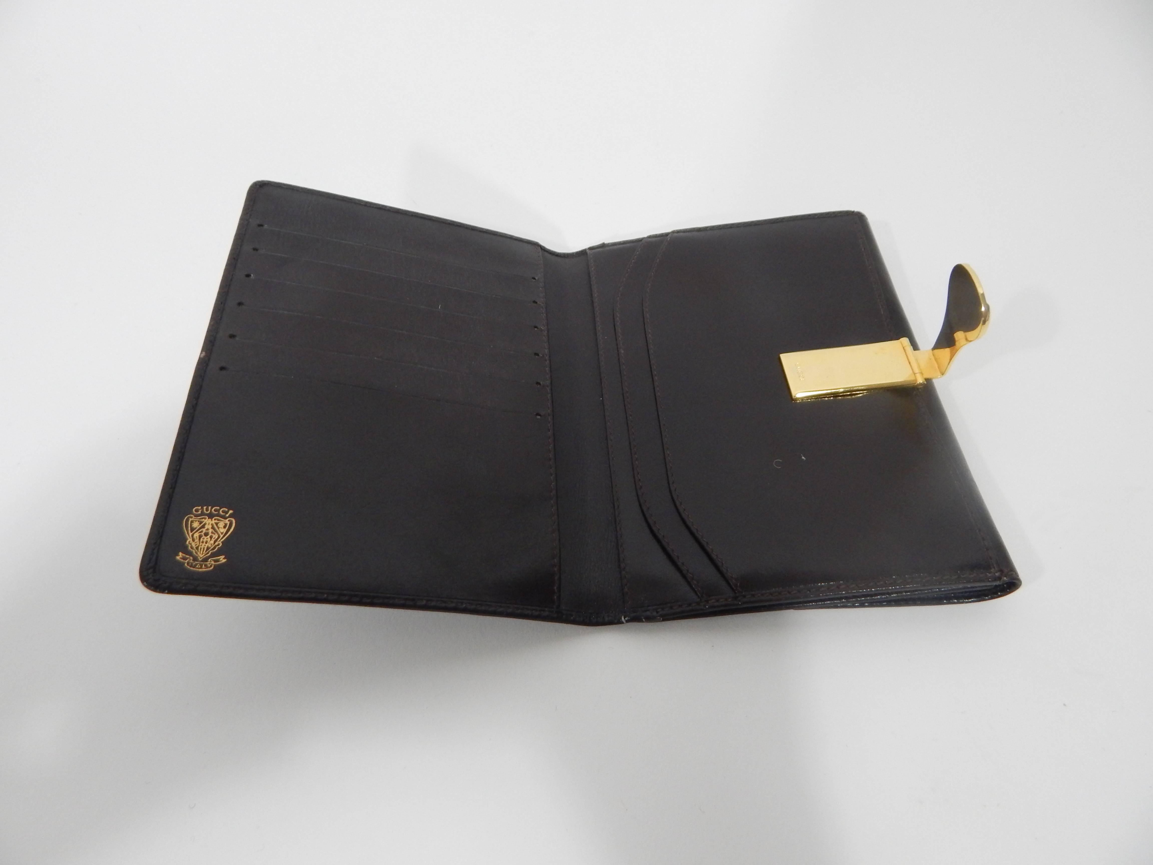 Chocolate Brown Leathr Gucci Wallet. Gold and Silver Clasp Closure with Gucci Markings. Circa late 1990s. Made in Italy. Excellent Condition with exception of some light wear around clasp area. 