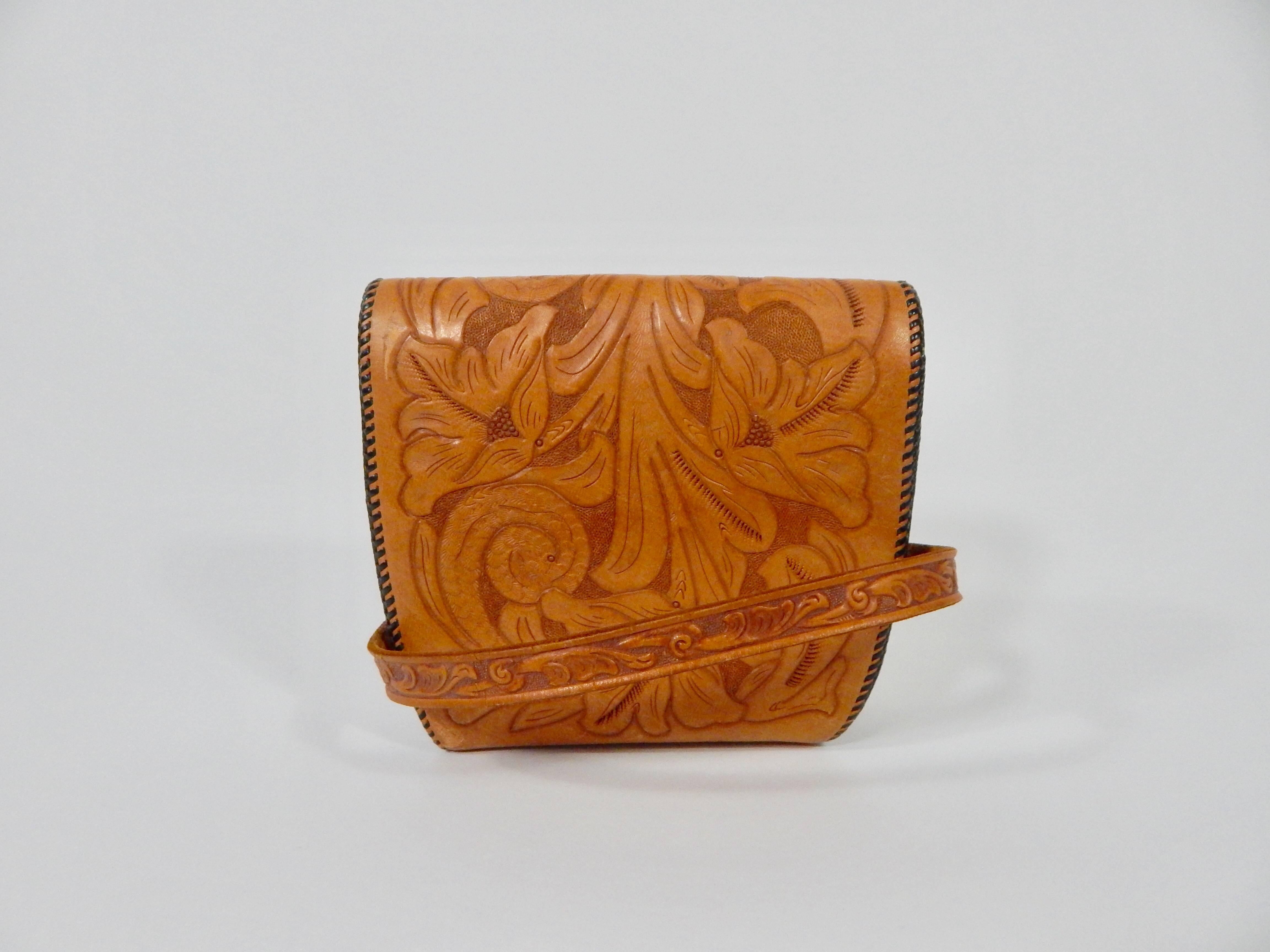 Embossed leather with brass hardware. 