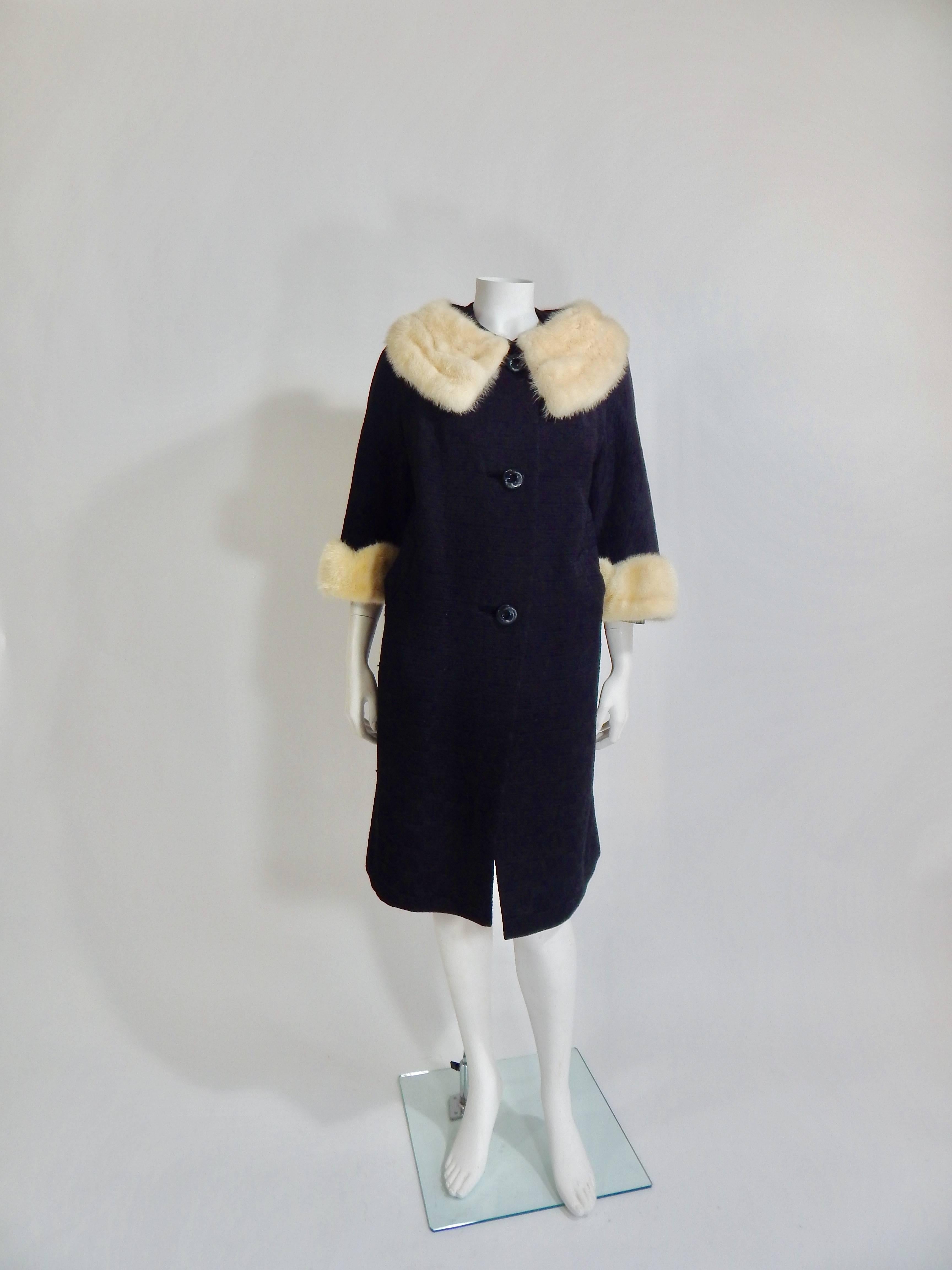 1950s Black Wool Coat with Off White Mink Collar and Cuff. Fully Lined in Black Silk Black Buttons. Snap Closure at neck. Nicely constructed. Interior and Exterior are in Excellent Condition.