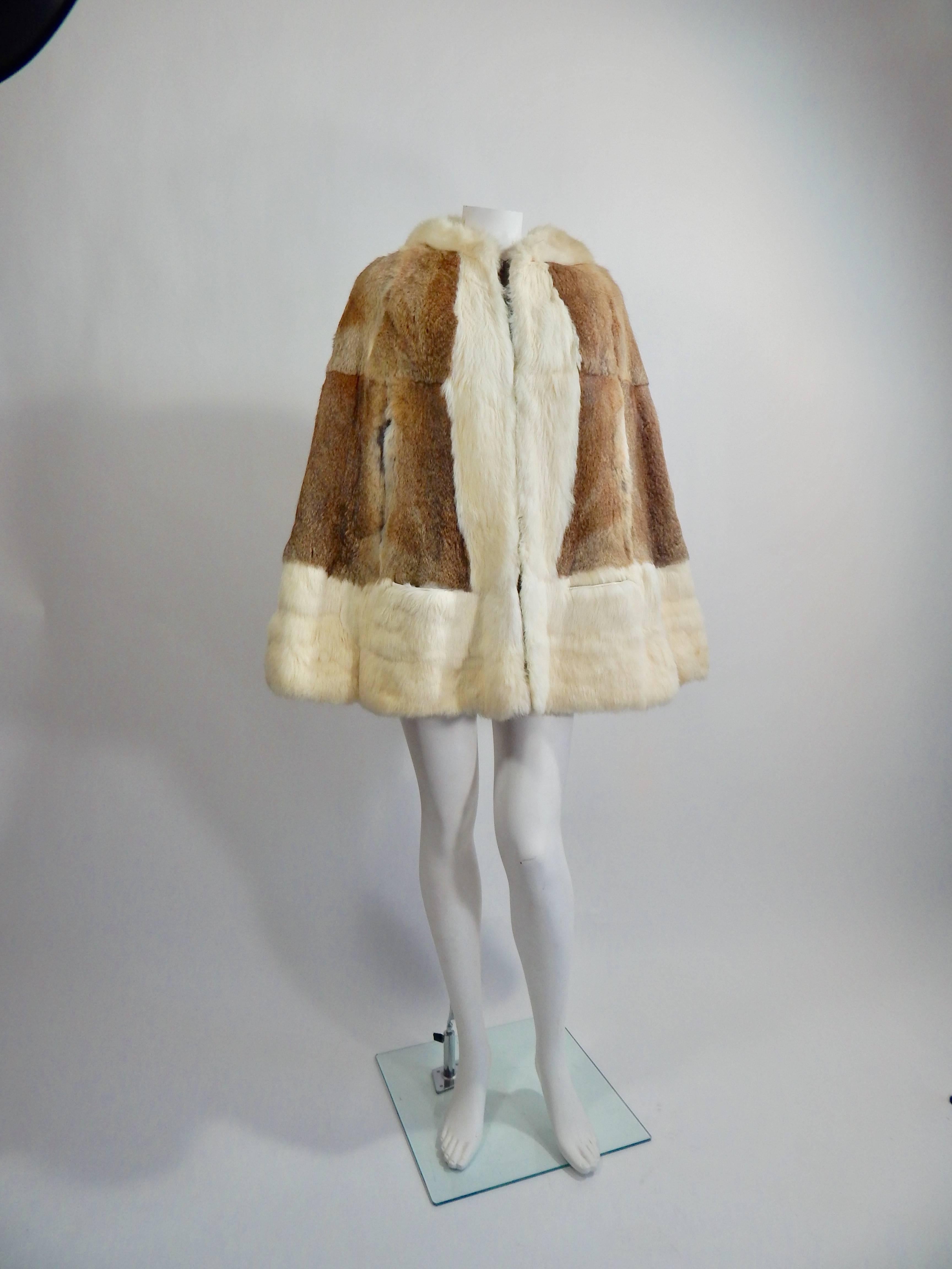 Gorgeous 1960s Fur Cape with Hood. Zipper up front Hook at neck. Arm holes and hand pockets. Fully lined in Chocolate Brown Silk. Size is versatile. Length is 30 inches. Interior and Exterior are both in Excellent Condition. 
