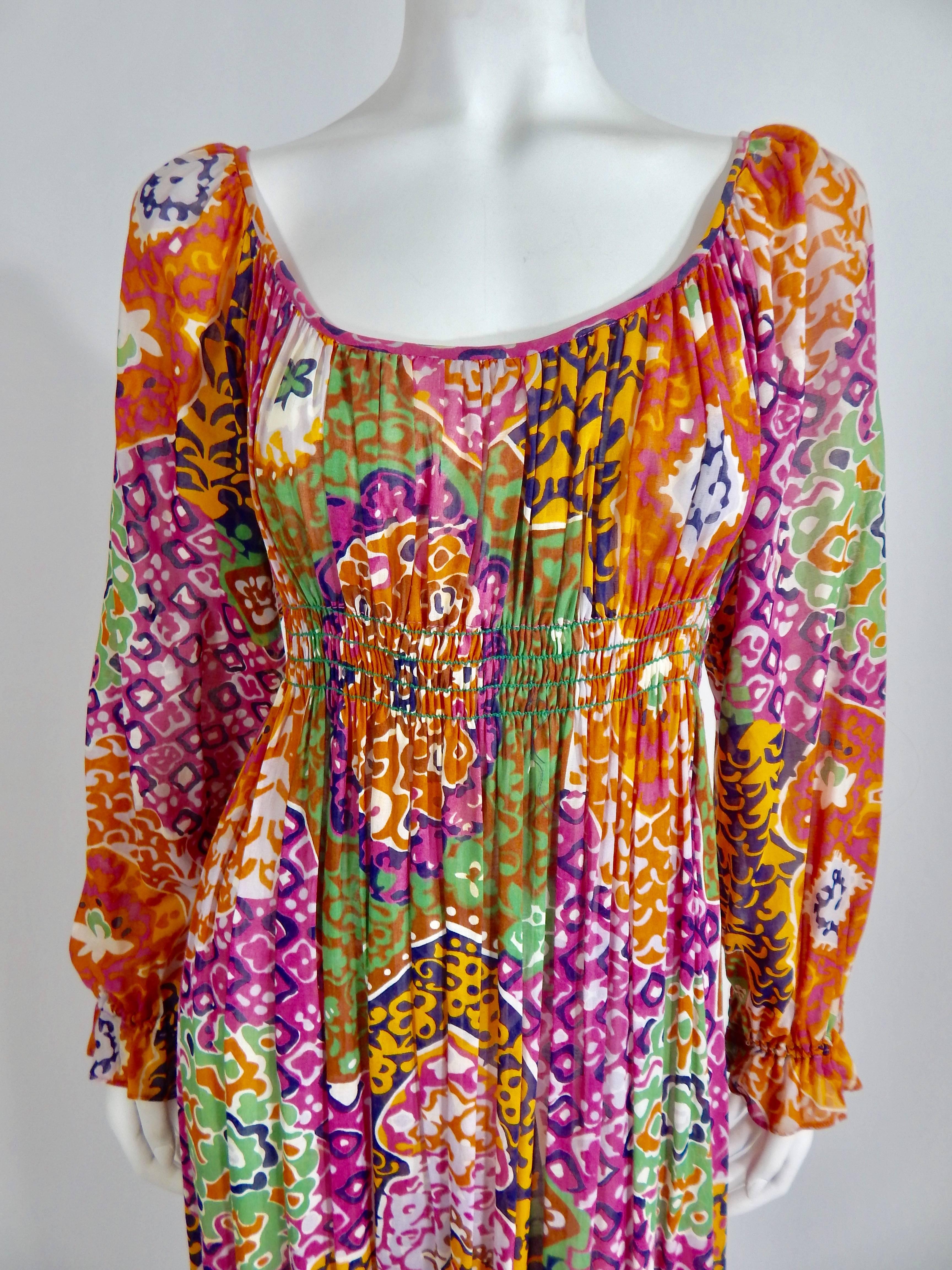 Vintage Late 1960s / Early 1970s Bohemian Maxi Dress. 100% Cotton Printed with bright colors of Pink, Purple, Orange, Green and Yellow. Slightly Sheer Fabric. Approximate modern day size 4 - 6. Excellent Condition. 
US Domestic Shipping in