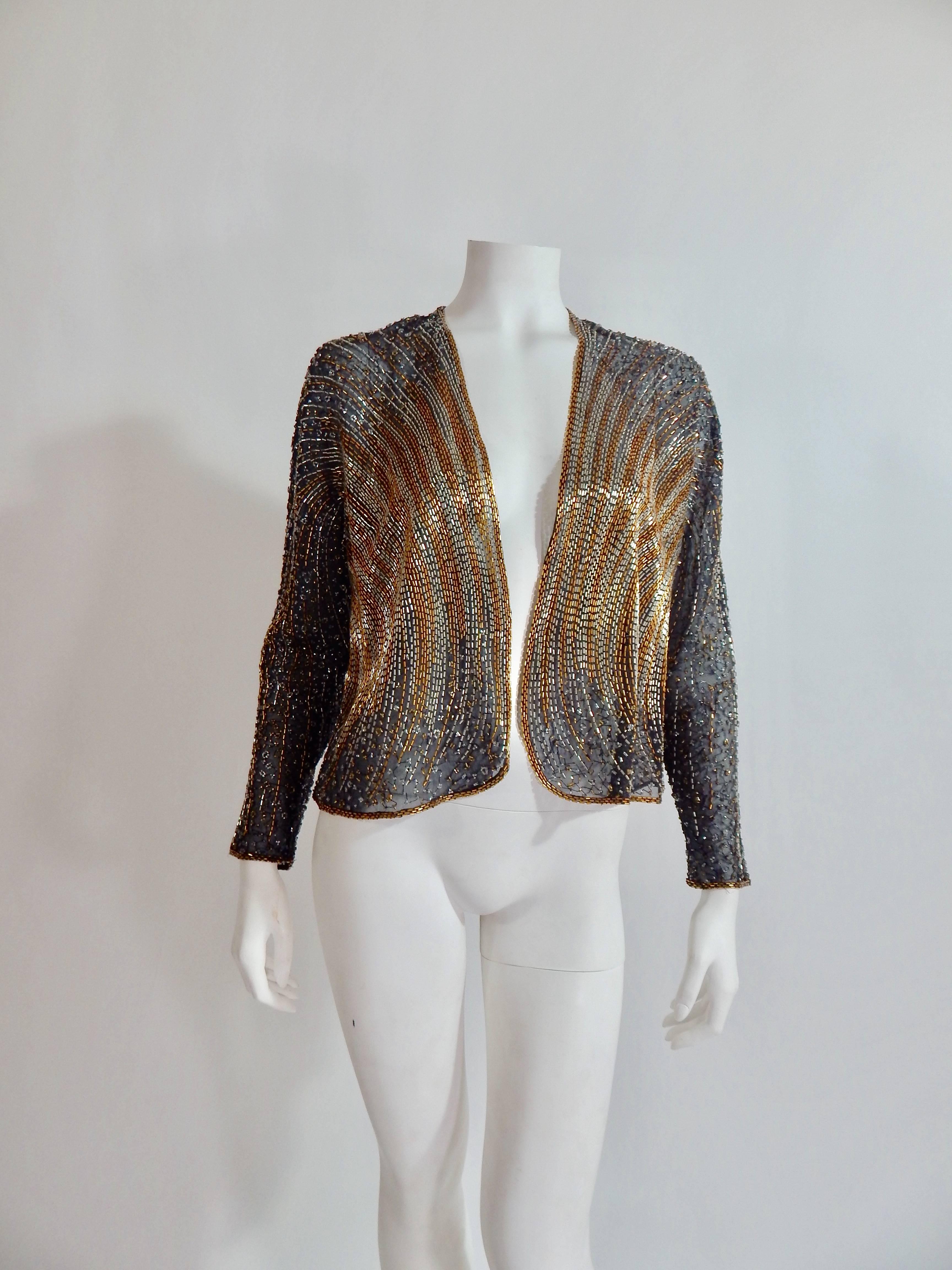 Fabulous 1970s / 1980s Vintage Halston Beaded Cover or Jacket. Sheer black with black, silver and gold beading. Bead work design in the style of disco and art deco. Versatile with formal gown or dress up denim. Tag reads size 4.