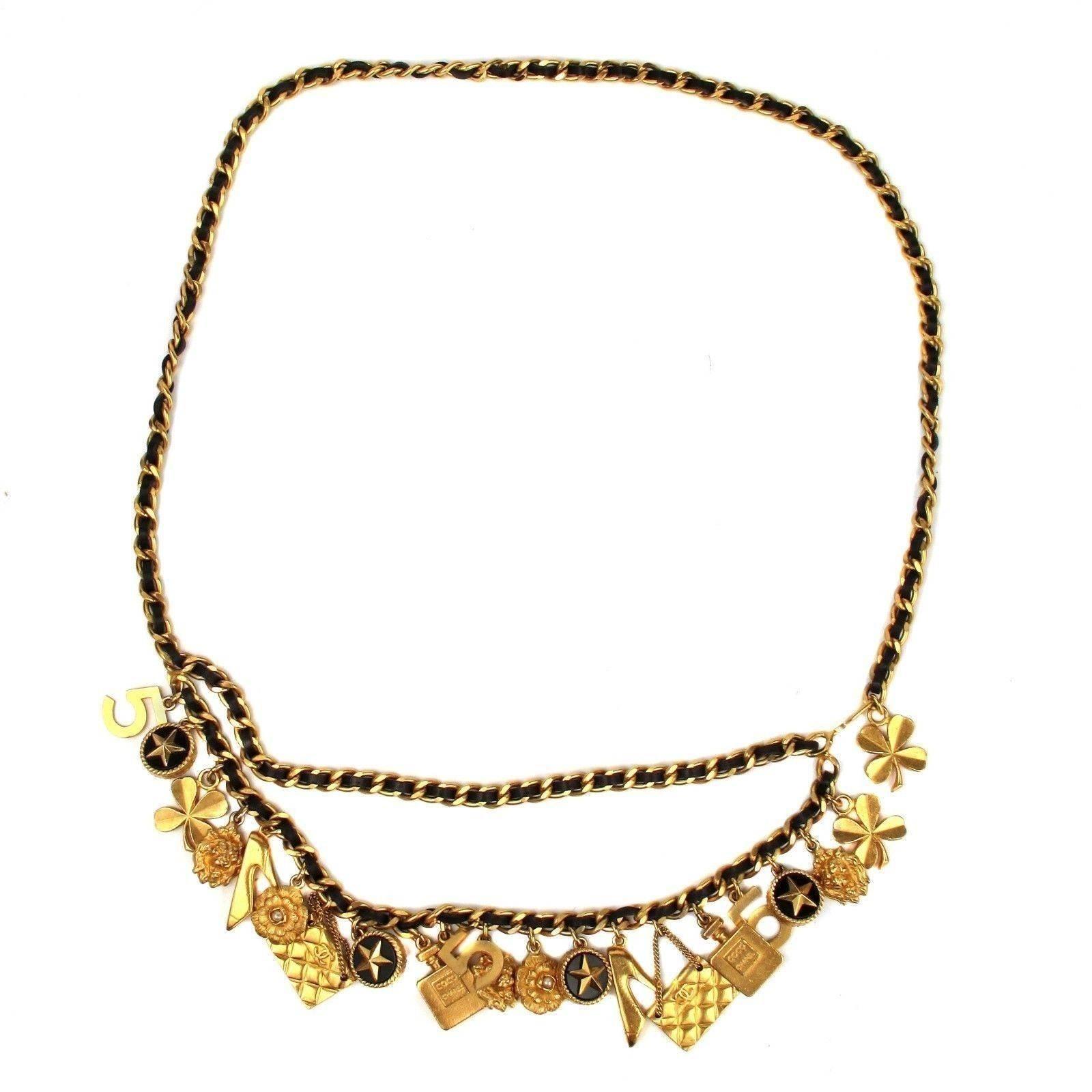 Chanel - Charm Necklace / Belt

Color: Black / Gold

Material: Leather / Metal

------------------------------------------------------------

Details:

- gold tone hardware

- various charms throughout 

- hook closure

- can be worn