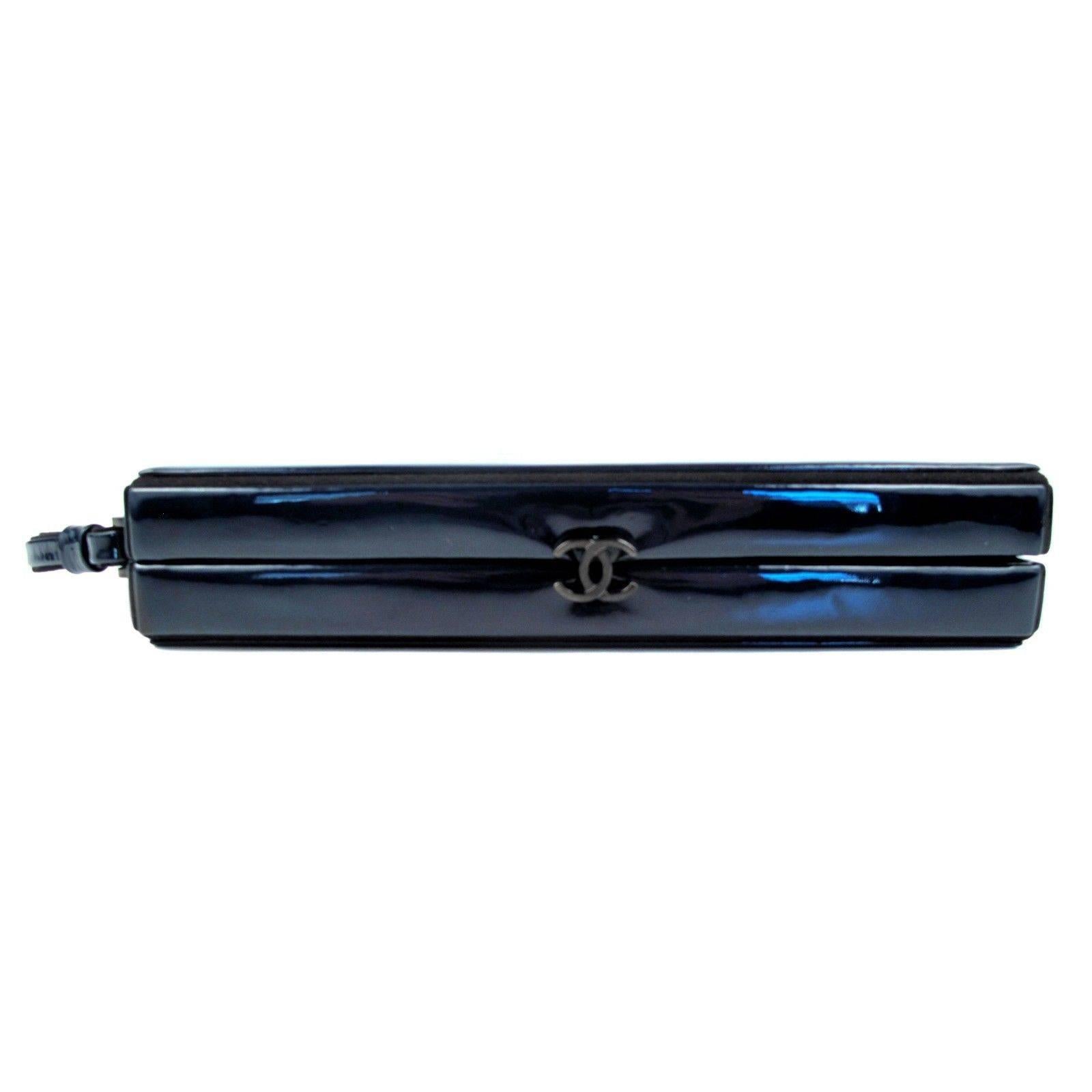 Chanel - Patent Leather Box Clutch

Color: Dark Navy Blue, almost black

Material: Patent Leather

------------------------------------------------------------

Details:

- wrist strap at side

- black trim

- gunmetal tone