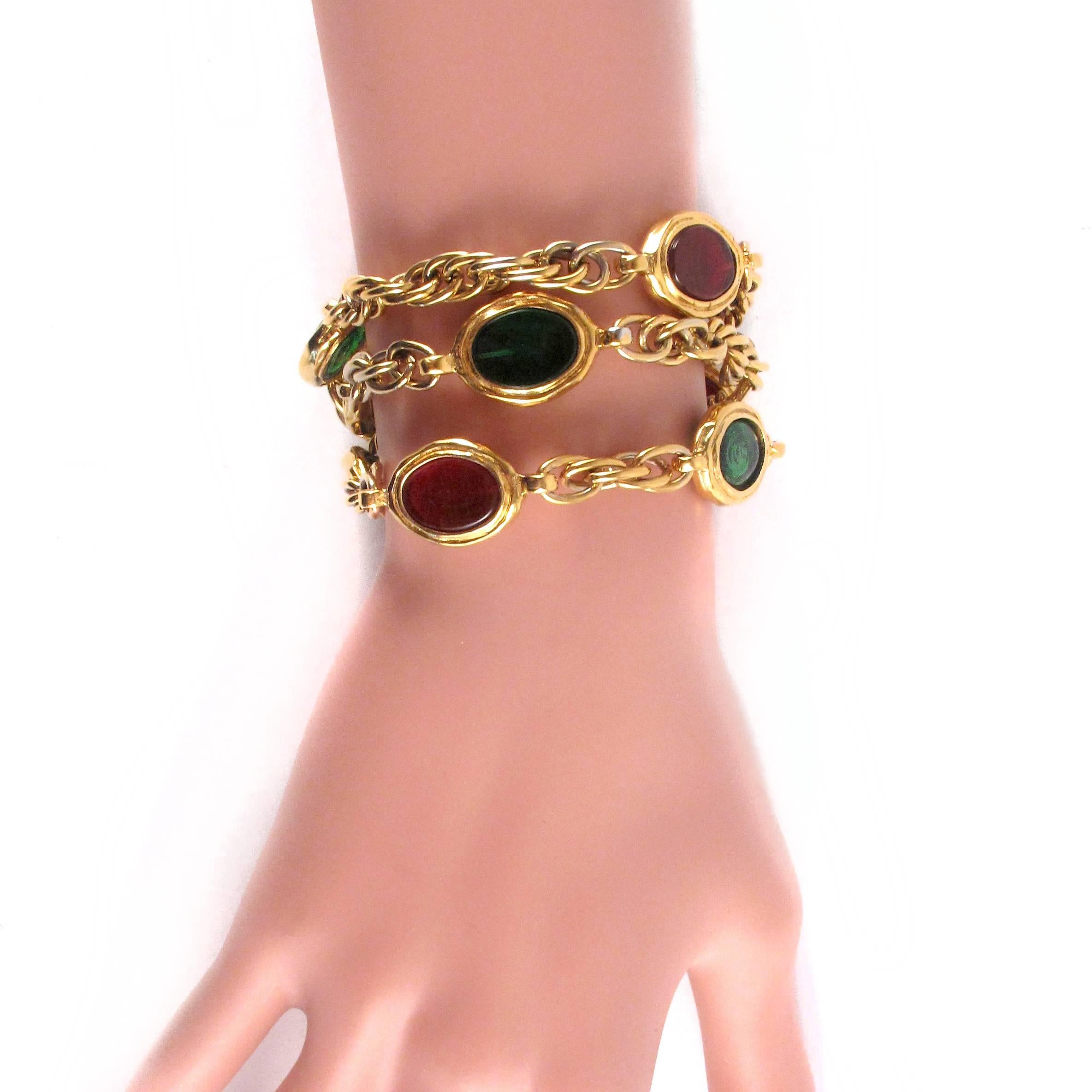 New - Deadstock Vintage with Tags

Chanel - Vintage Gripoix Bracelet

Color: Gold

Material: Metal

------------------------------------------------------------

Details:

- gold tone hardware

- green & red glass beads throughout

-