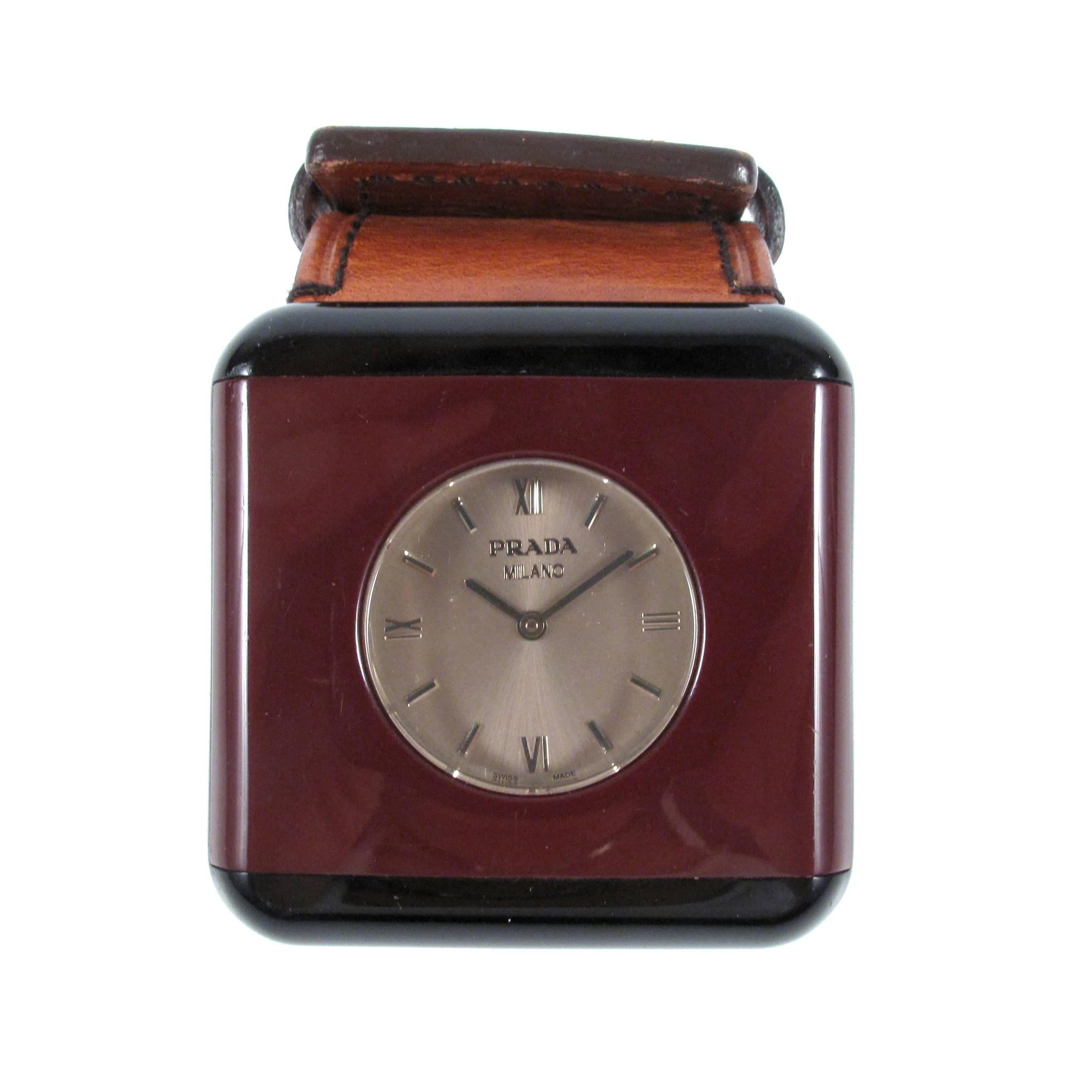 Prada - Watch Bracelet

Color: Maroon / Black / Brown

Material: Resin / Leather

------------------------------------------------------------

Details:

- leather band

- two tone watch face

- roman numerals

- stainless steel
