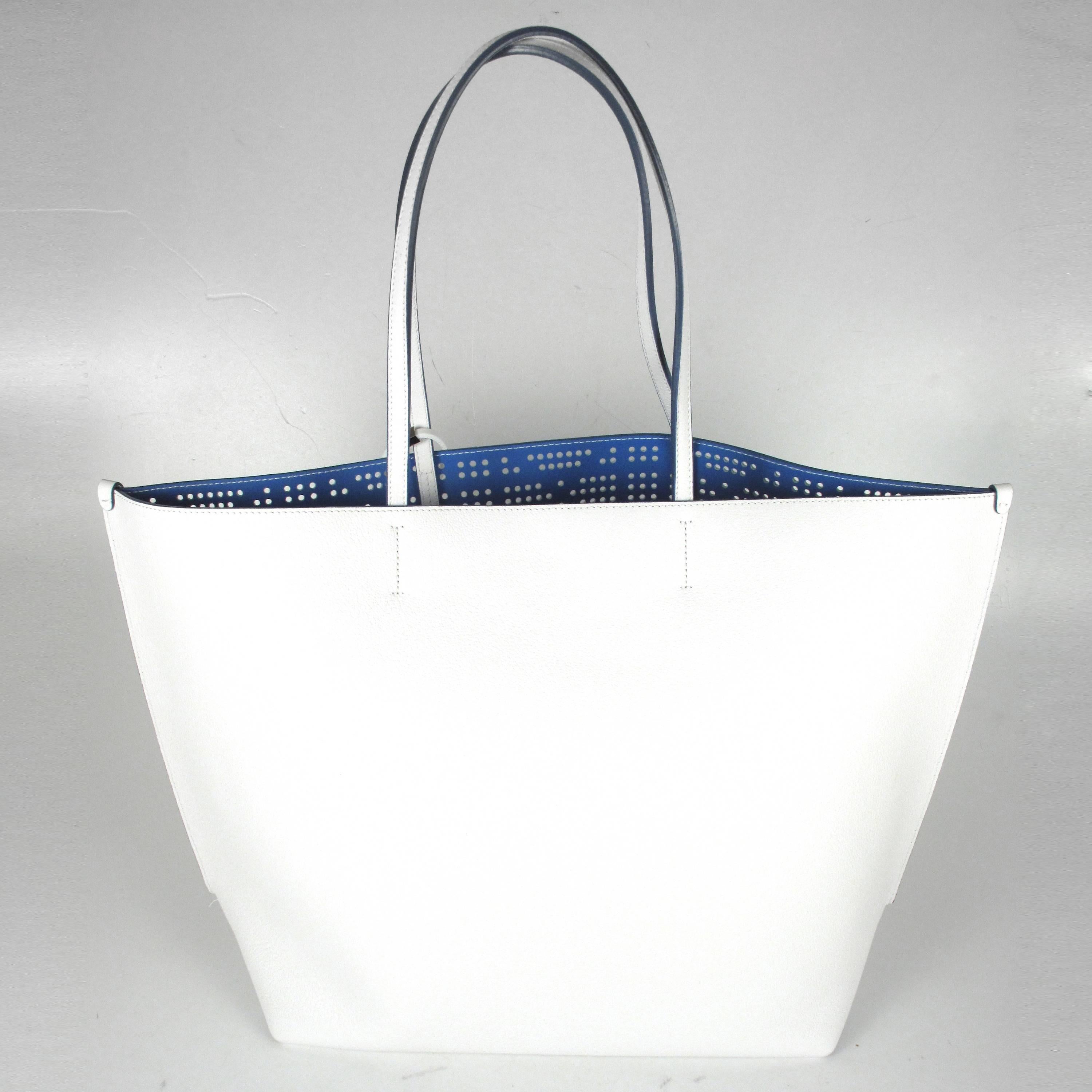 Dior - Dioriva Tote Bag

Color: White

Material: Leather

------------------------------------------------------------

Details:

- blue lining

- dior letter charms - multicolored

- perforated leather at front

- interior snap