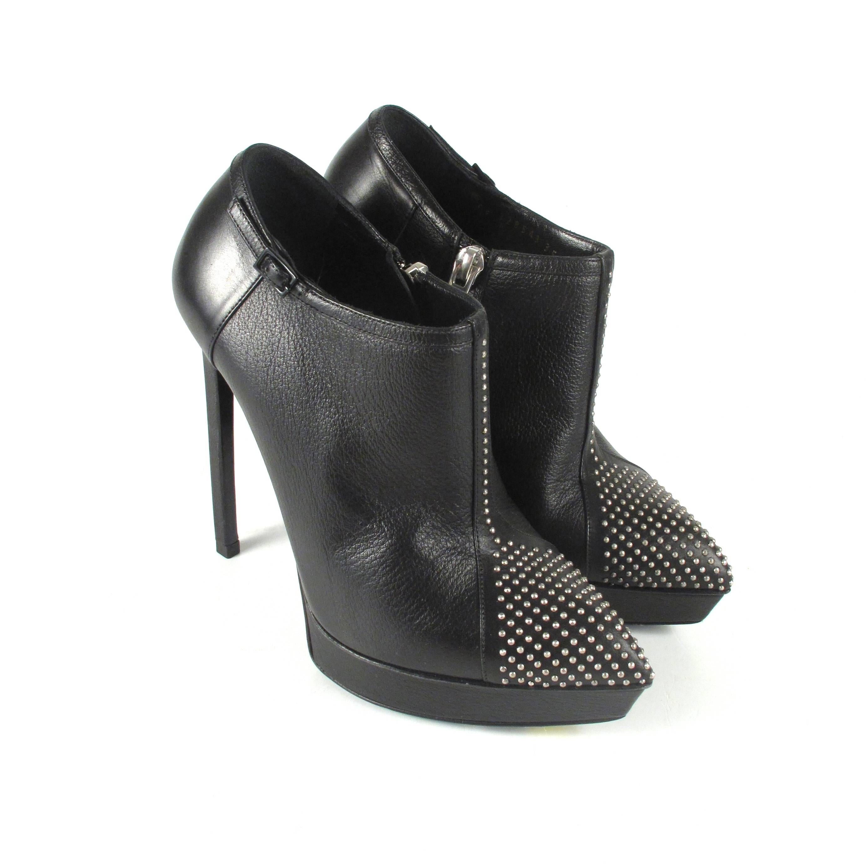 Saint Laurent - Studded Ankle Booties

Size: 35 - US 5

Color: Black

Material: Leather

------------------------------------------------------------

Details:

- silver tone hardware

- studded embellishments at toe

- zip closure