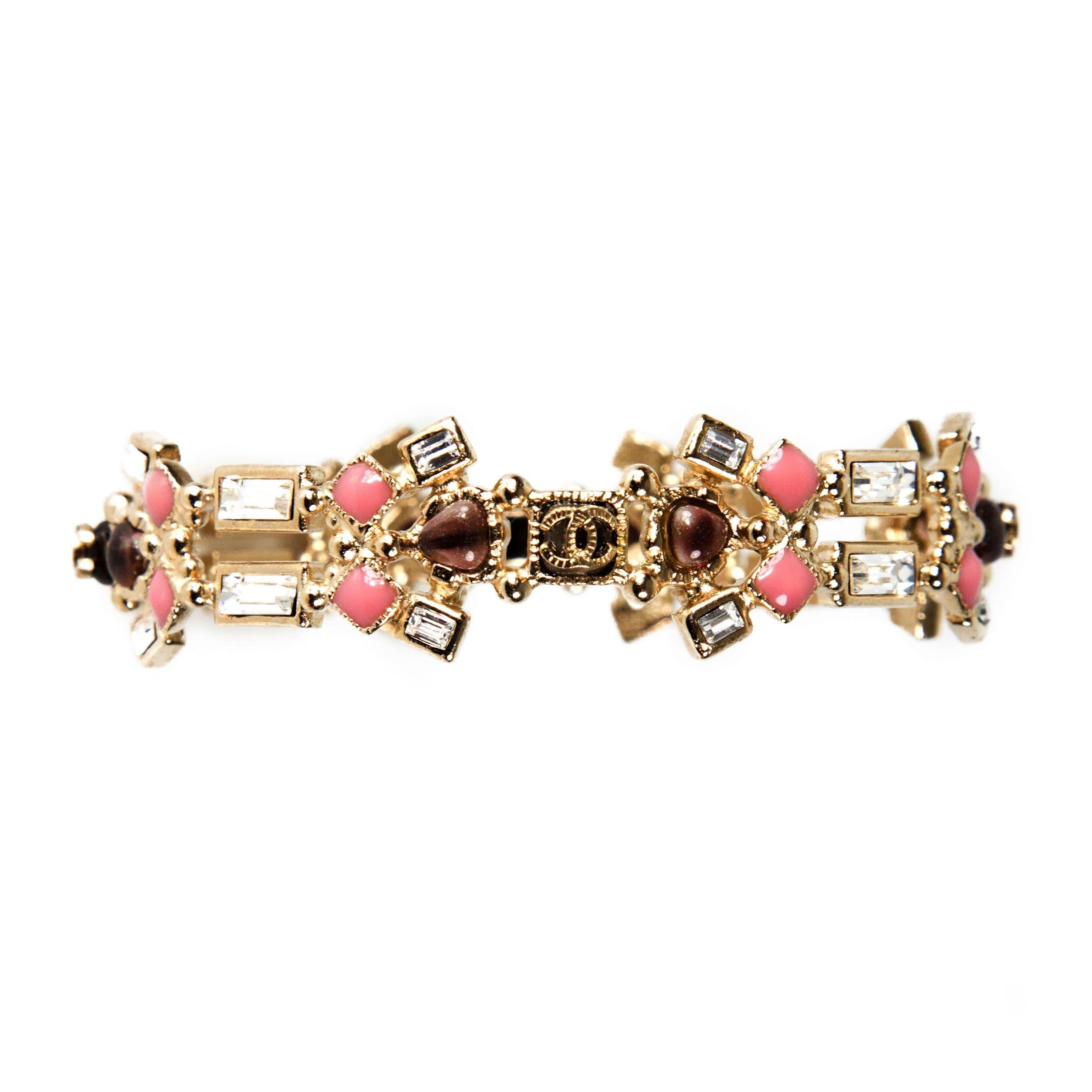 Chanel - Crystal Gem Gripoix Bracelet

Color: Gold / Pink / Brown

Material: Metal / Crystal

------------------------------------------------------------
 
Details:

- cut outs throughout

- gold tone hardware

- CC logo at brown