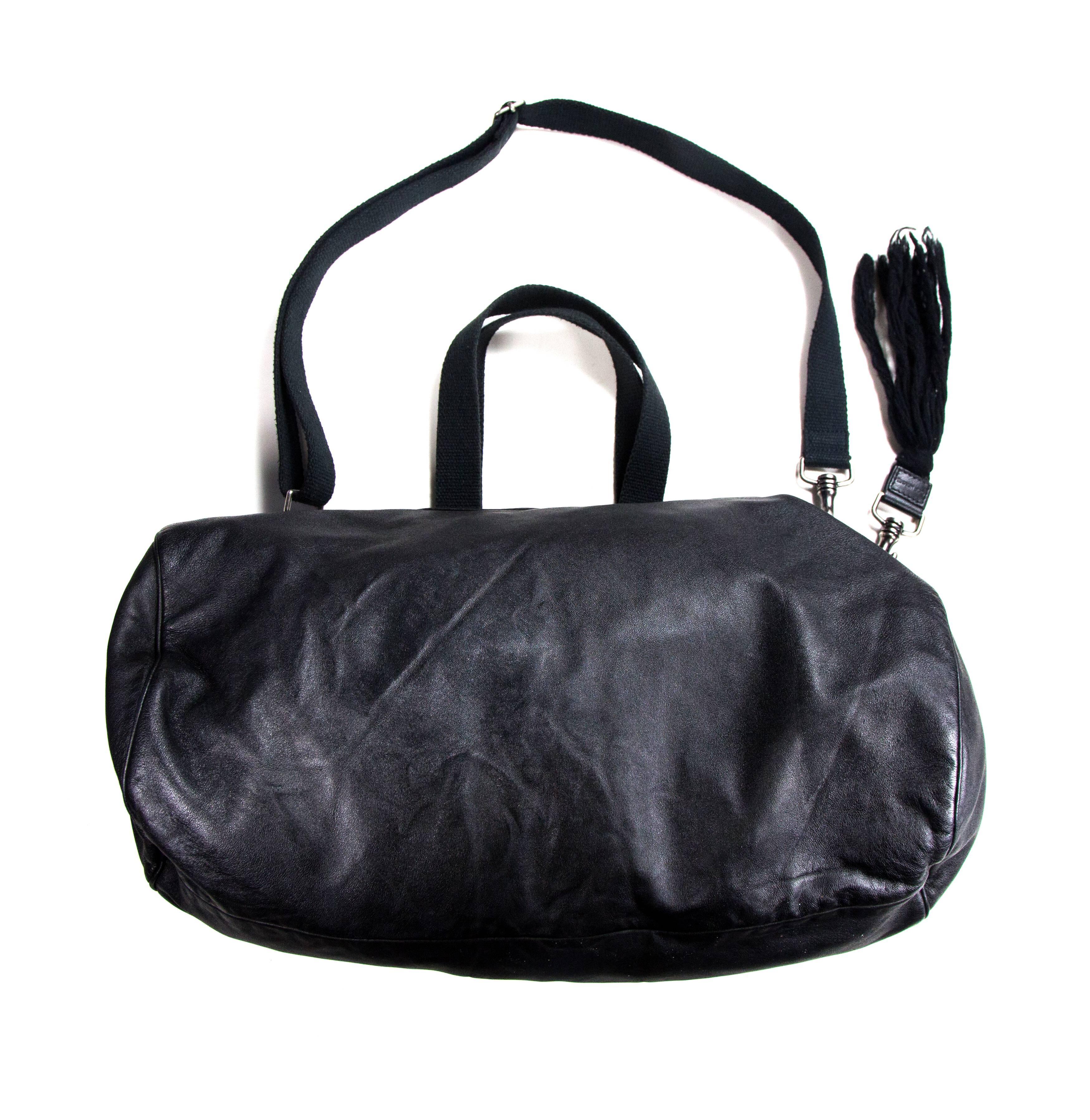 Dior Homme - Rare Deville Duffle Bag by Hedi Slimane

Color: Black

Material: Leather

------------------------------------------------------------

Details:

- silver tone hardware

- adjustable detachable shoulder strap

- four