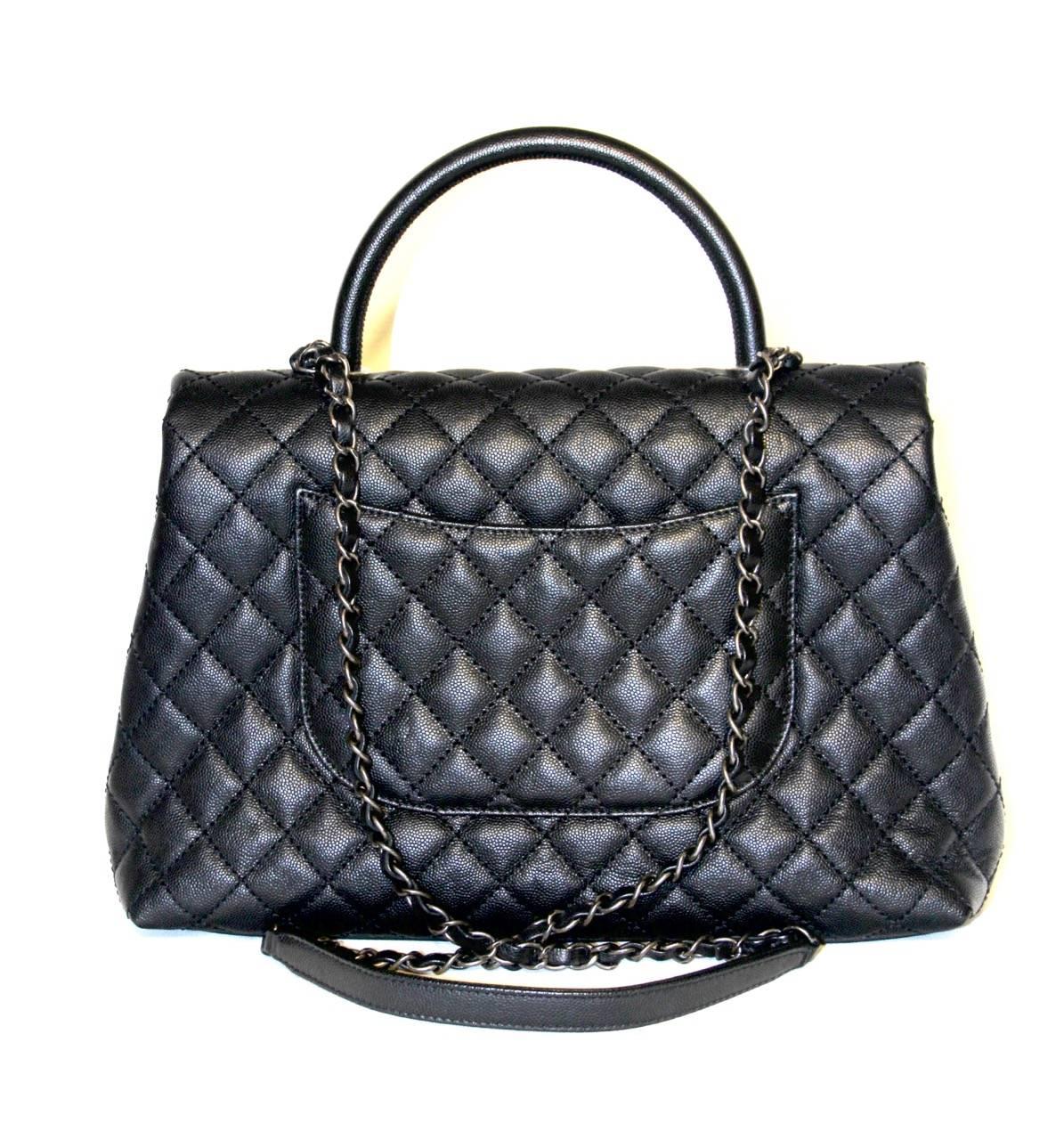 This fancy Chanel Coco Handle flap bag is the perfect everyday bag. 

It has an amazing trapezoid shape with the CC closure, a flat pocket at the back and features a single top handle and an interwoven chain/leather shoulder strap.

Collection: