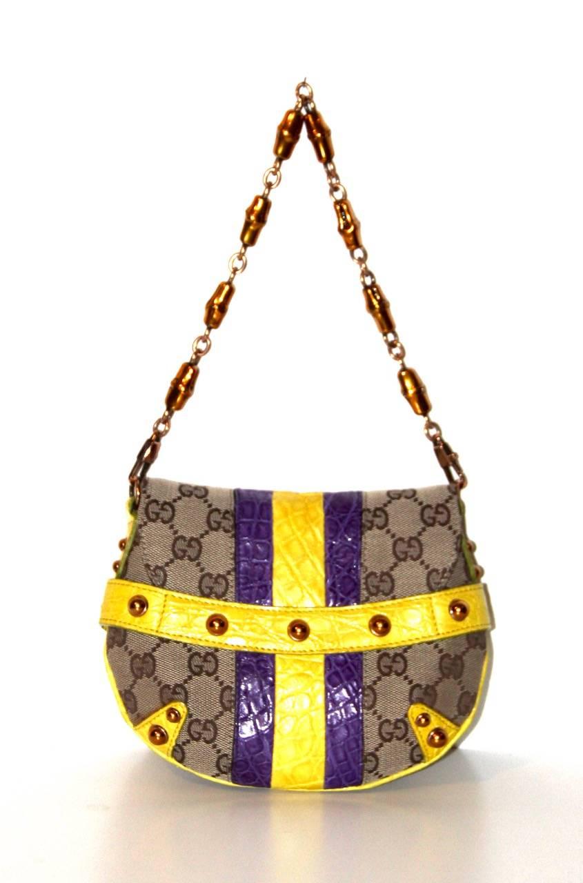 An exceptional Tom Ford for Gucci signature bag.
Limited Edition.

Flap bag with wide central stripes of yellow and purple crocodile skin. 
Golden Gucci’s classic bamboo designed chain.
Amazing handcrafted jeweled snake head with Swarovski