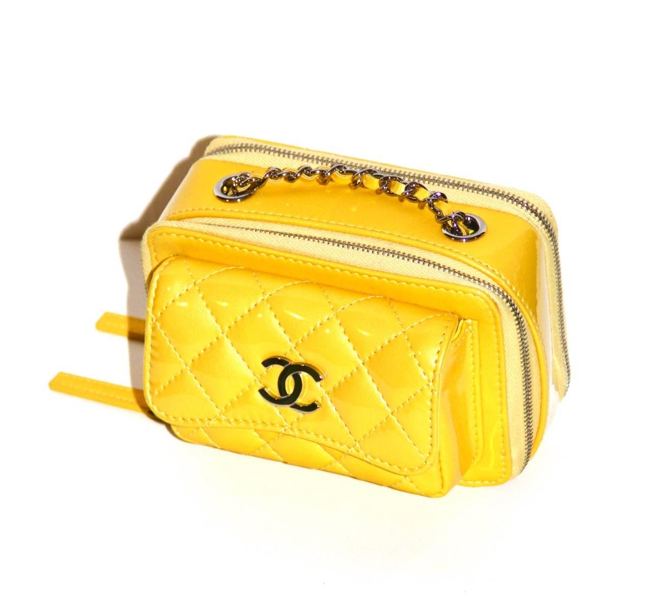 This stylish cross-body case is crafted of yellow quilted iridescent calfskin and features a interwoven leather shoulder strap. 

Exterior single flap pocket with snap closure, dual zip compartments, interior slip pocket, tonal silk