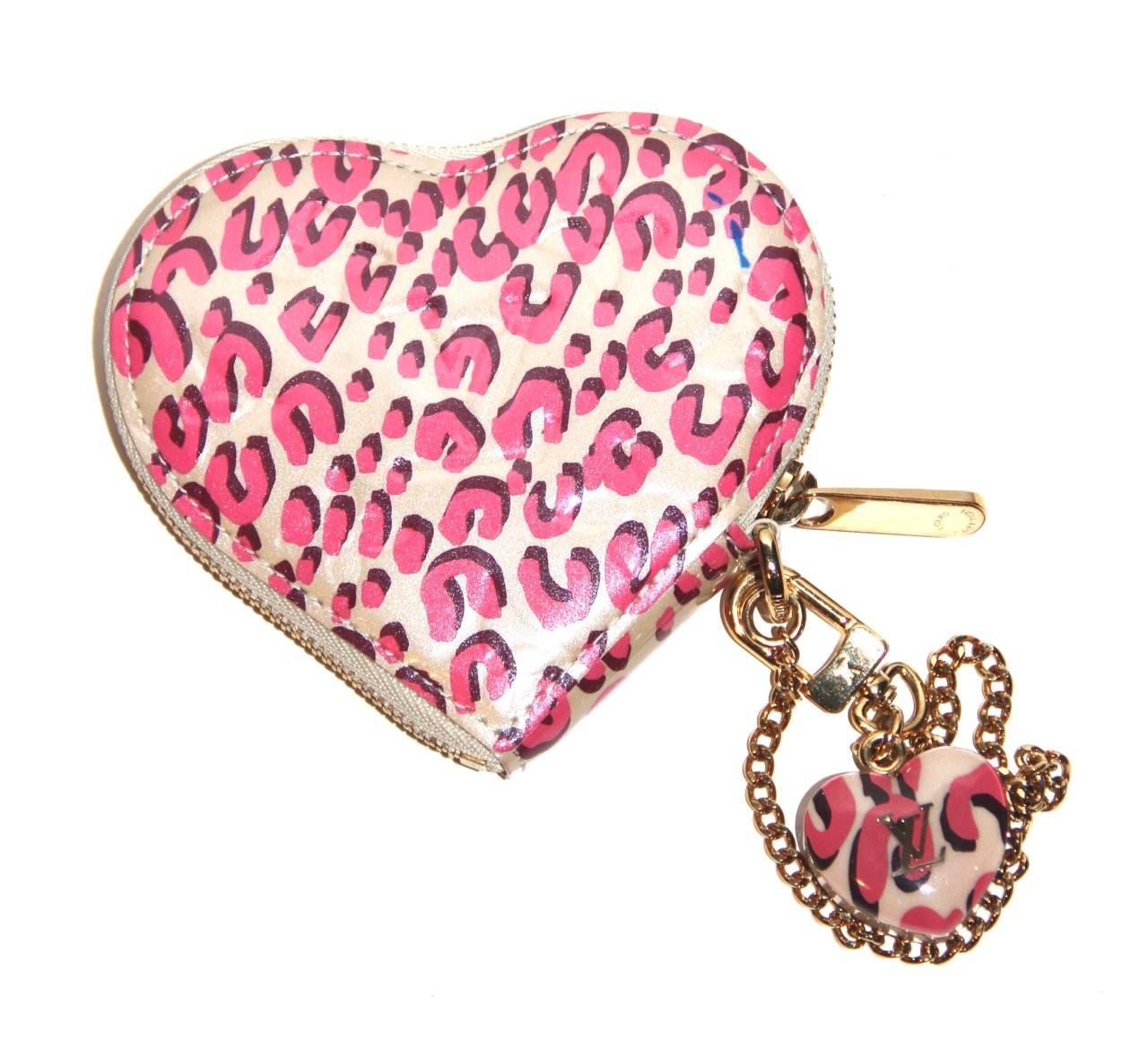 Ultra-chic and stylish heart coin purse from the Stephen Sprouse Collection for Louis Vuitton. 

Louis Vuitton monogram embossed leopard print in pink and white patent leather. It features a gold-tone hardware, a top brass zip fastening, a brass