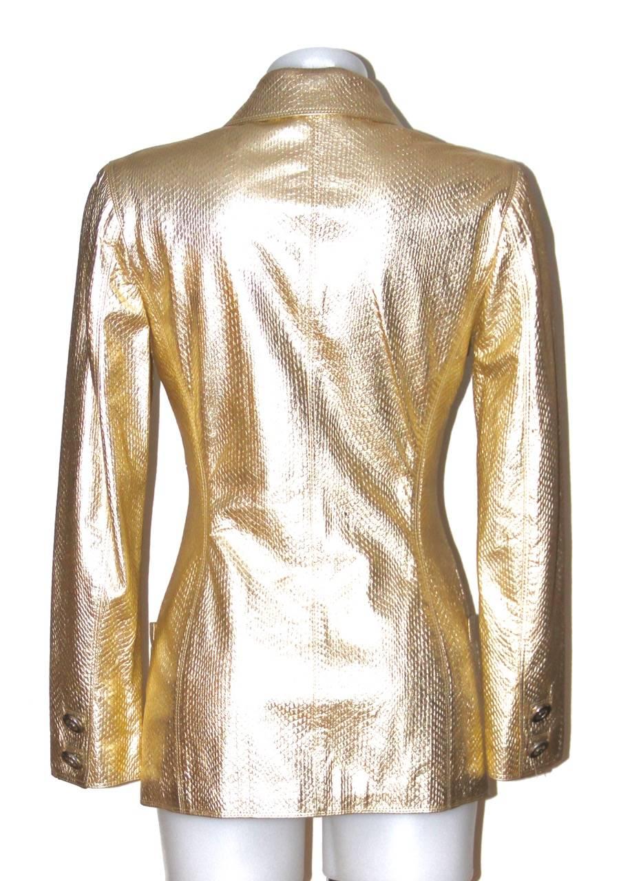 A signature style jacket by Gianni Versace. Gold lambskin jacket with gold-tone Medusa buttons. Two hip slit pockets. Lined with Medusa print cloth

Collection: Vintage
Fabric: Leather 
Color: Gold
Size: S
Measurements: Back under collar: 68.5 cm;
