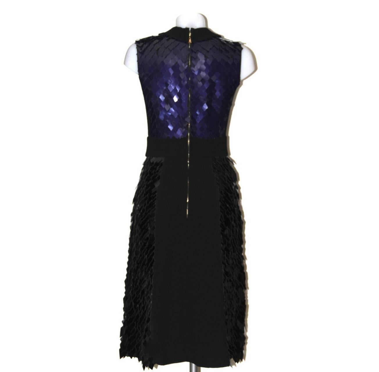 From the Louis Vuitton RTW Fall-Winter 2011 collection, this fancy dress is exquisitely cut in a silhouette inspired by the Brigitte Bardot-style. Crafted of black wool and saturated with shimmering purple XL square sequins, this luxurious