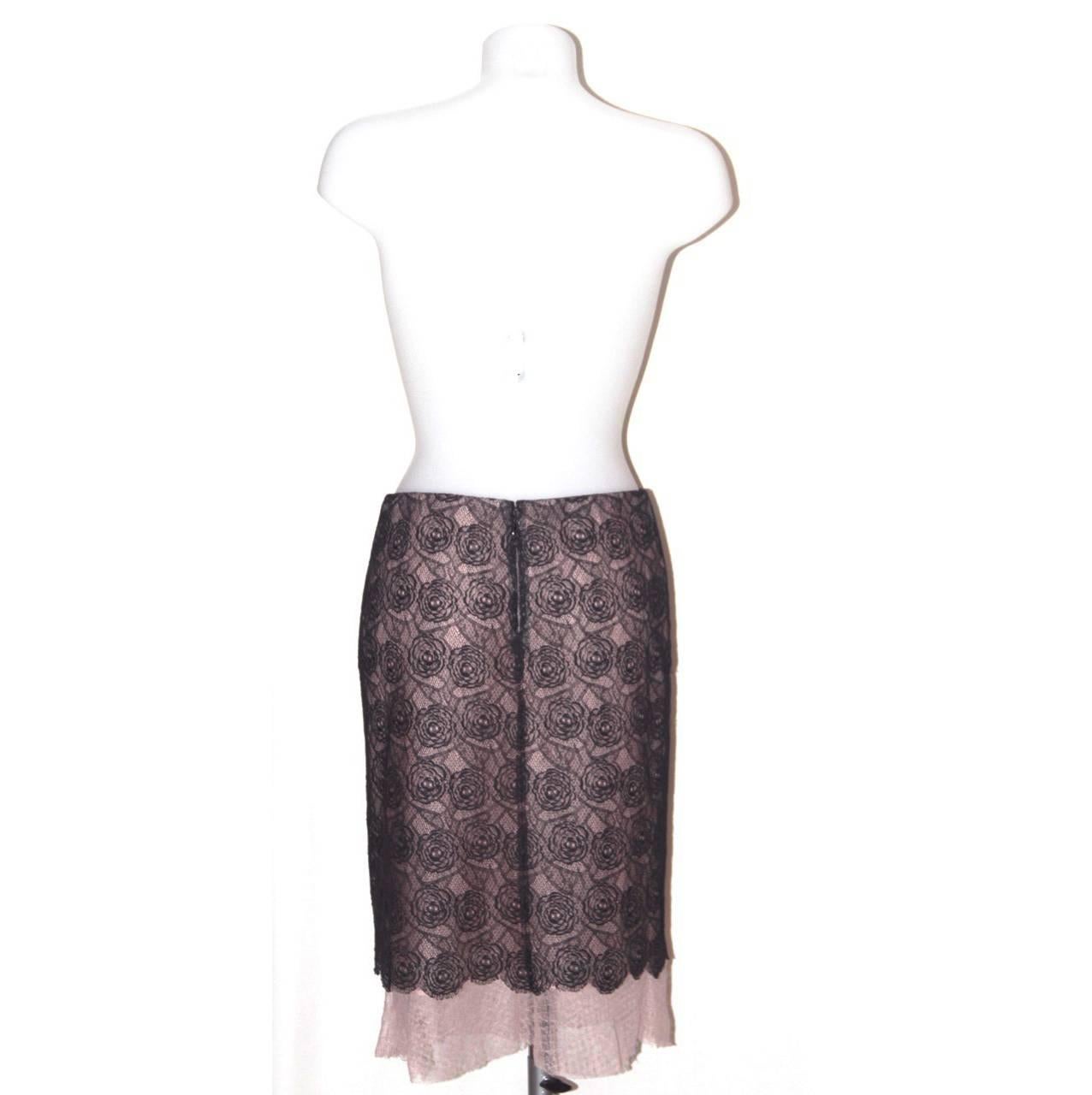 Both delicate and sophisticated, this skirt from Chanel is a must-have for a romantic look. 

Collection: Spring 03
Fabric: Lace: cotton blend; Under dress: polyamide; Lining: silk
Color: Blush pink, black
Size: FR 38 
Measurements: Lenght: 60