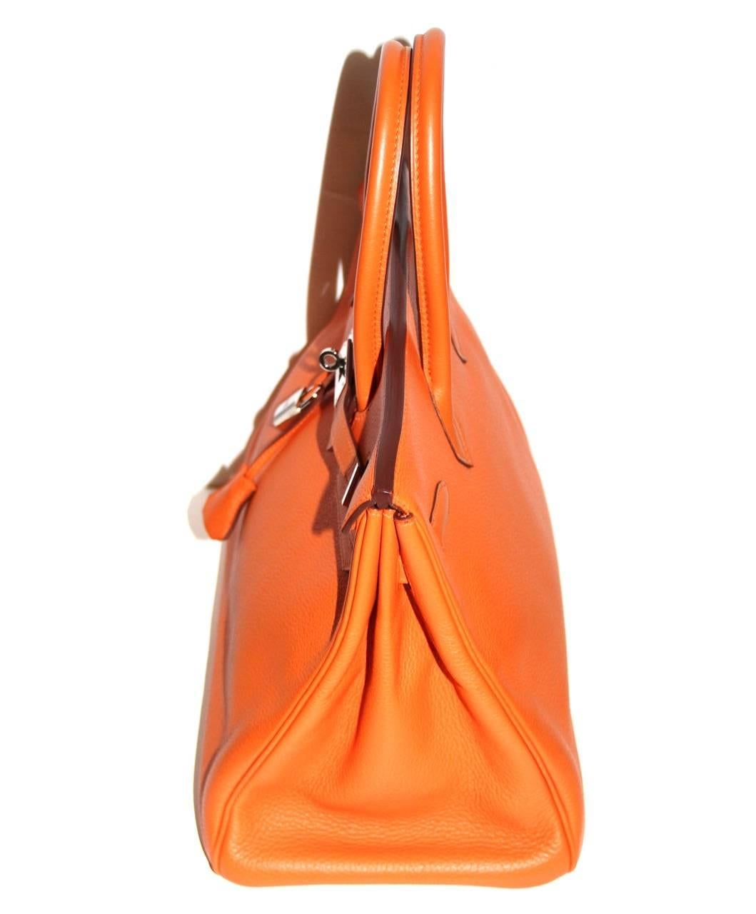 Orange Hermes is the most famous Hermes color.  This timeless bag is in excellent condition, like new.

Collection: 2003
Leather: Togo
Color: Orange
Hardware: Palladium
Interior: One slit pocket, one zip pocket; orange
Measurements: 35cm