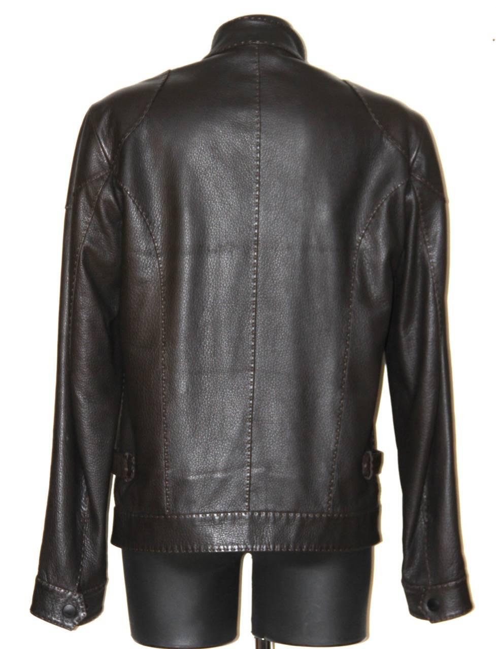 Elegant brown leather jacket from Fendi Selleria featuting tonal topstitching throughout, a mandarin collar with snap closure, snap closure cuff, two chest zip pockets, two waist slit pockets and a central front zip closure and two internal
