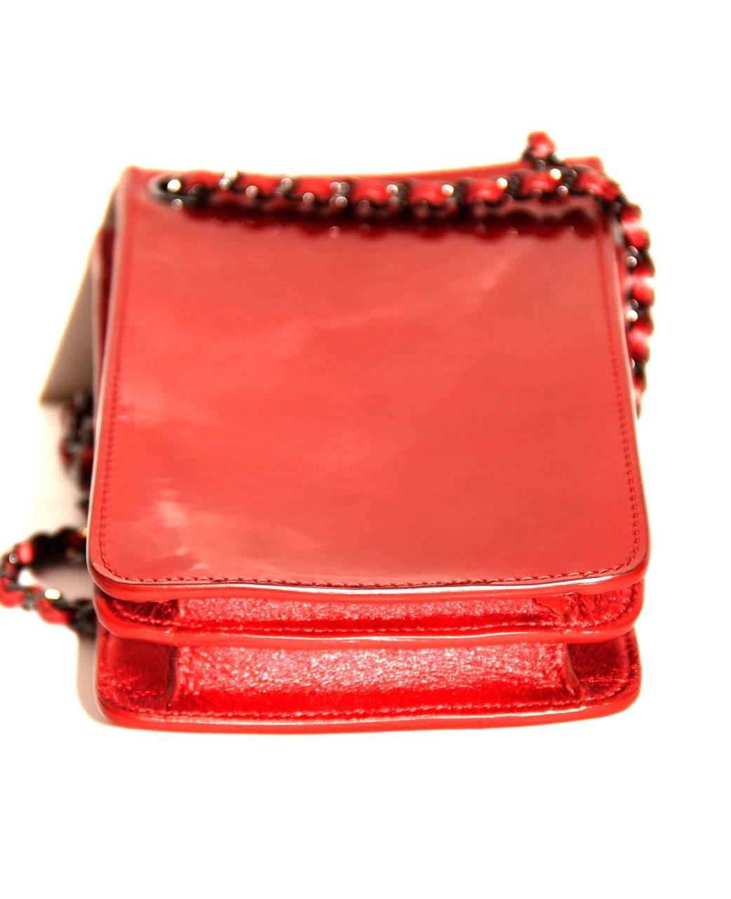Fun and a must-have Chanel tech accessories: crossbody smartphone case bag.

Collection: 2014
Leather: Patent leather
Color: Red
Hardware: Silver-tone
Interior: Three compartments, grey cloth lining
Measurements: Length 10 cm x Height 15.5 cm x