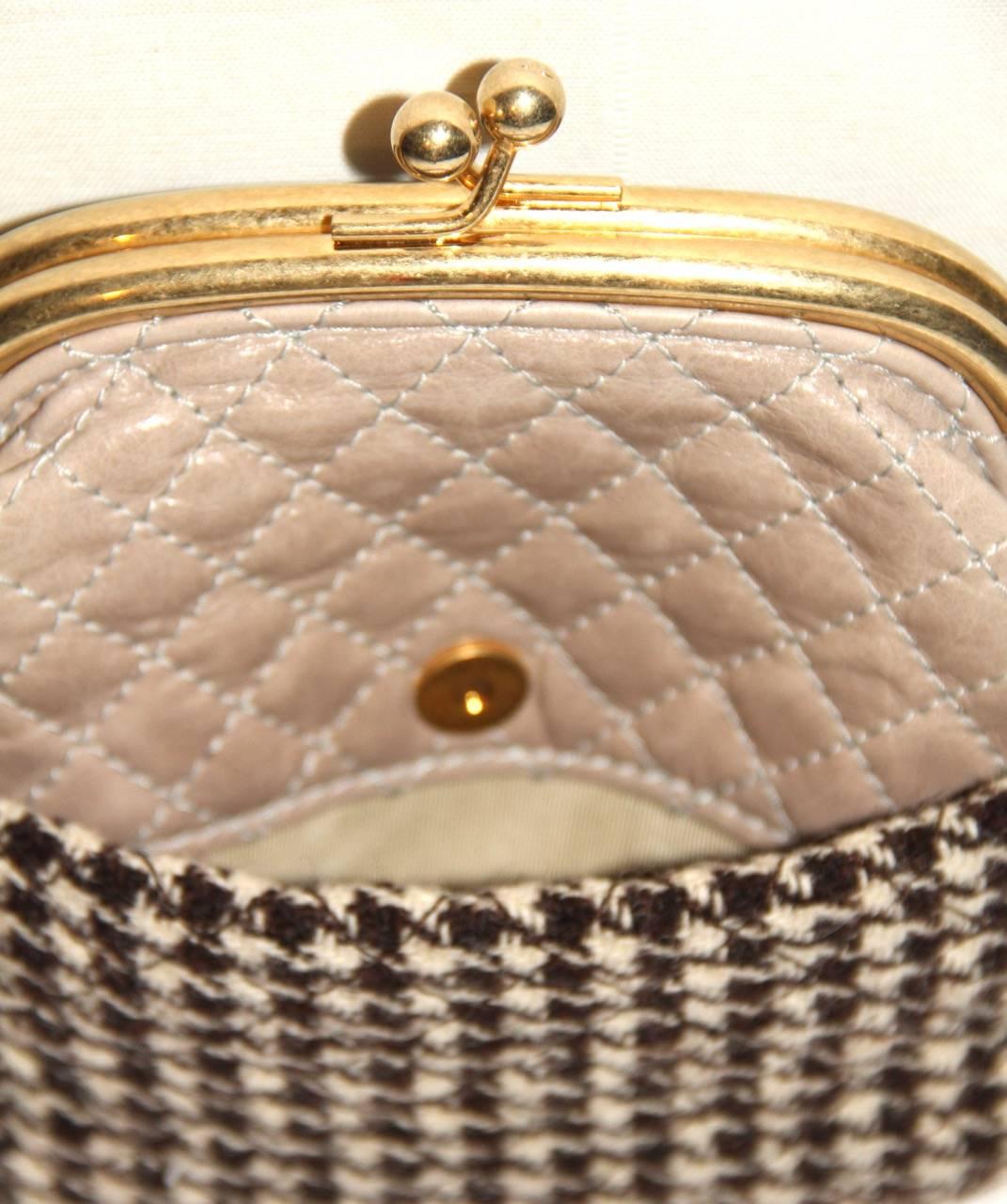 Lovely Chanel wool clutch from the Fall/Winter 2015 Collection. Its design features a XL purse carried as a crossbody bag. The clutch features a thick gold-tone shoulder strap with a leather pad and an exterior flat pocket with clasp closure.