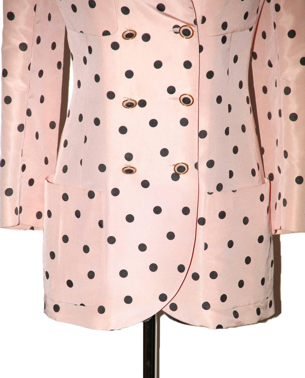 Elegant and timeless Chanel pink and black polka dot jacket. It features a black velvet collar, 6 front buttons and 4 pockets. The blazer is fully lined of tonal pink silk with embroidered CC. 
Tags have been removed. 
It sizes as a FR 36/38.