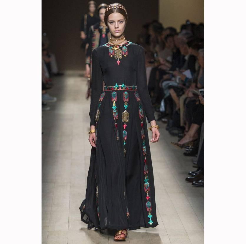 Stunning black dress from Valentino seen on the catwalk for the Spring-Summer 2014 Ready-to-Wear Collection. The dress shows no sign of wear. 
It features a multicolored embroidery and bead embellishments, a pleated skirt and a hidden back zipper.