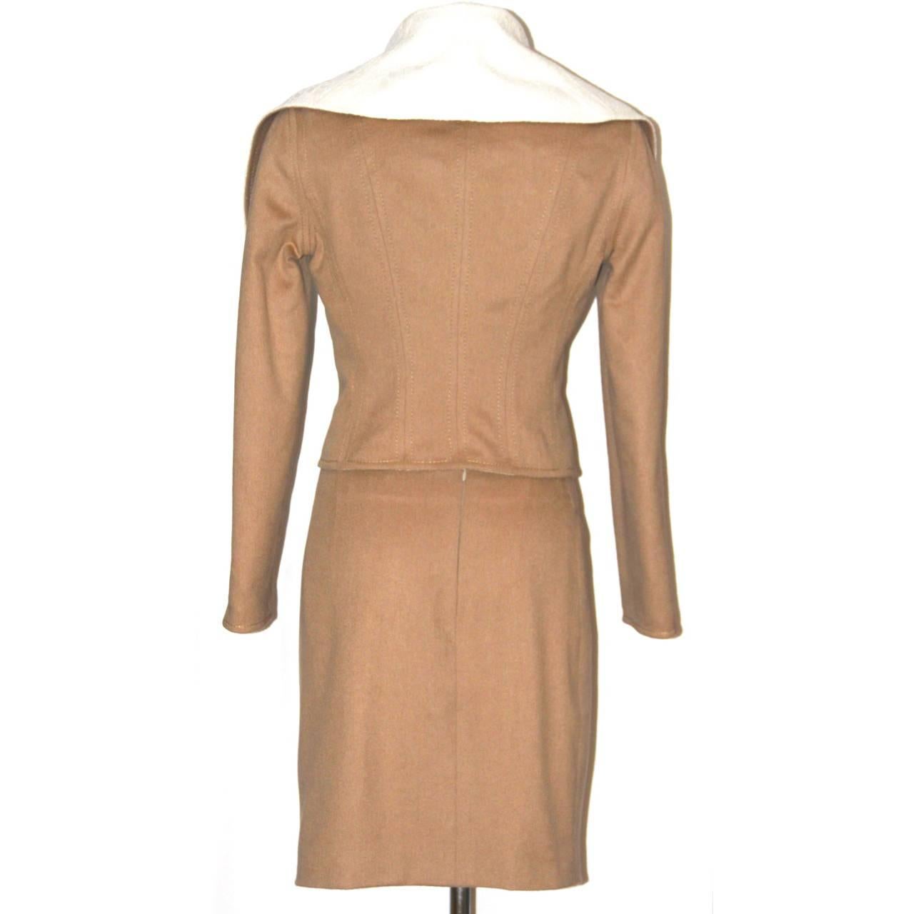 Chic and very feminine suit from the prestigious French fashion house. 
The jacket features a folder top, a corseted shape as a Christian Dior signature style and three front buttons. The classic pencil skirt features a high rise, a rear zip and a
