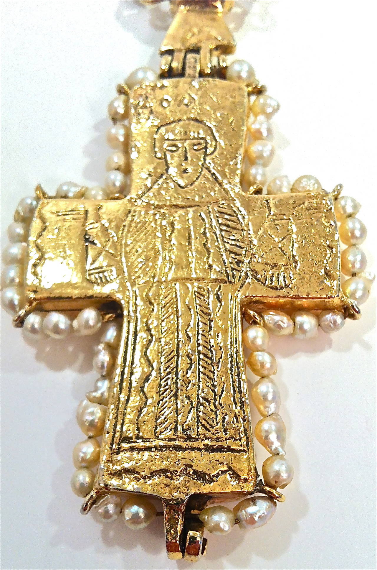 Exceedingly rare gilded Byzantine cross made in the 1950's by Robert Goossens, commissioned by Mademoiselle Chanel. Inspired by a gold and enamel reliquary cross displayed at the British Museum, this rich gold gilt metal cross is double faced with