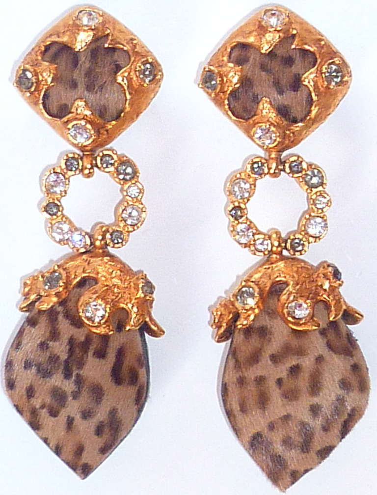 Elegant Christian Lacroix long dangle earrings made of leather imitating panther fur, set in beautiful gilded metalwork enhanced with smoky and clear Swarovsky crystals.
Marked Christian Lacroix and Made in France on back. Original clasps work