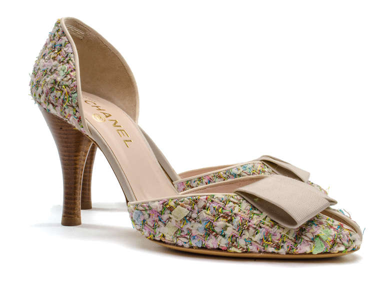 Step into spring in these gorgeous pastel Chanel peep toe heels. These heels feature teal, yellow, green, pink, red pastel throughout, satin bow detail at vamp, peep toe, stacked wooden heel. Heel measures approximately 4