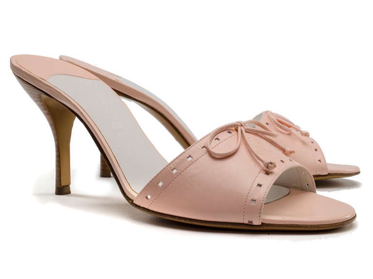 Perfect for a Sunday afternoon brunch! These sandals feature light pink leather slides throughout, perforated detailing with infamous CC detailing at toe and stacked wooden heel. Heel measures approximately 3.75