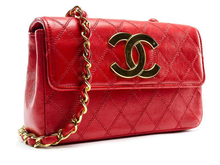 Let this bag make a statement all on it's own! Stunning Chanel vintage bag is perfect for day or night and can be easily dressed up or down! This stunning vintage beauty features red lambskin leather throughout, flap detail, oversized CC gold