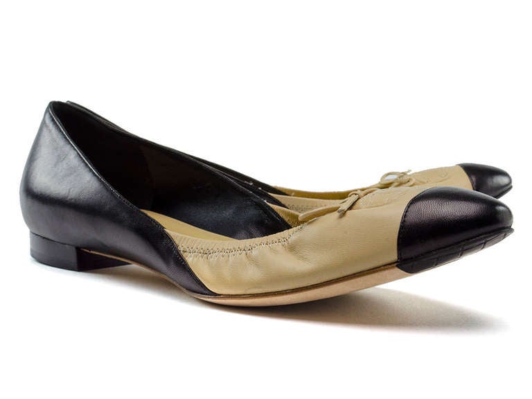 We love these hot to trot Chanel ballerina flats in nude and black leather ballerina flats. These flats feature a black cap toe, bow detail at vamp as well as iconic CC detail, colorblocked detail, slight heel. MSRP $620!

Includes: Original Box.