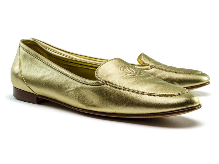 Keep it casually chic in these glam Chanel loafers! These loafers are featured in gold leather with iconic 'CC' detail at vamp, slight heel. MSRP $455.