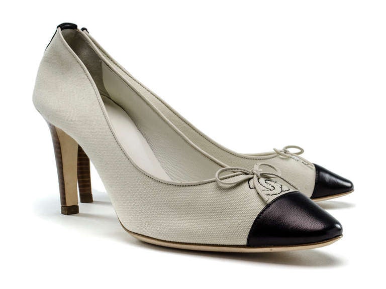 Perfect for summer these Chanel canvas heels are perfect paired with a pair of cropped jeans or sundress! These heels feature ivory canvas throughout with ivory leather bow detail at vamp as well as piping, contrasting navy blue stitching with
