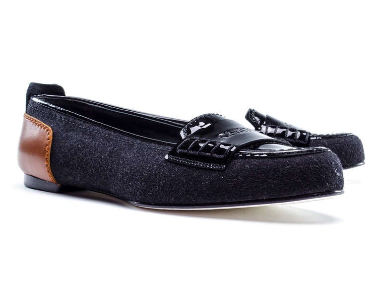 A hint of menswear in these perfectly on trend Chanel loafers! These loafers feature grey wool throughout, black patent leather at vamp with 'CHANEL' logo, brown leather at back of the heel. MSRP $660!