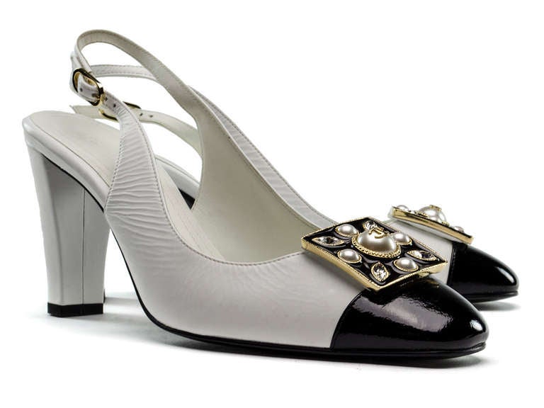 Rare & extremely hard to find Chanel patent leather heels will be sure to hold a special place in your heart and closet! These heels are featured in a black and white colorblocked patent leather with a black patent leather cap toe and white