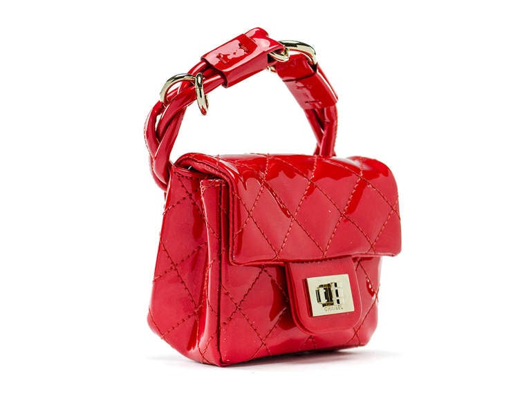 Step out in style in this Chanel runway ankle bag in red patent leather. Silver tone hardware.