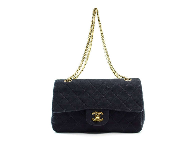 Keep it casual in this Chanel beauty--perfect for the weekend with the kids! The Chanel jersey flap is featured in black knit fabric, gold tone hardware, gold tone chain strap, one exterior pouch pocket. Interior features double flap details, one